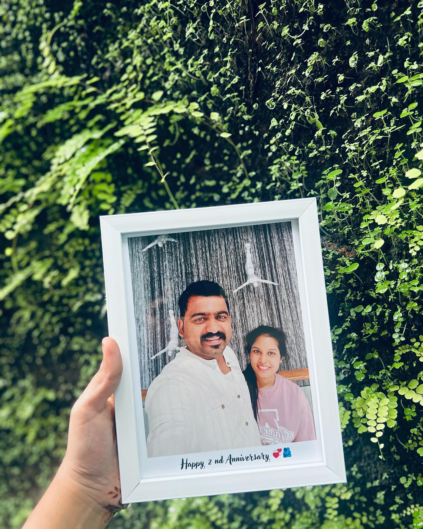 A personalized tabletop photo frame printed with your favourite couple picture and a custom anniversary caption.