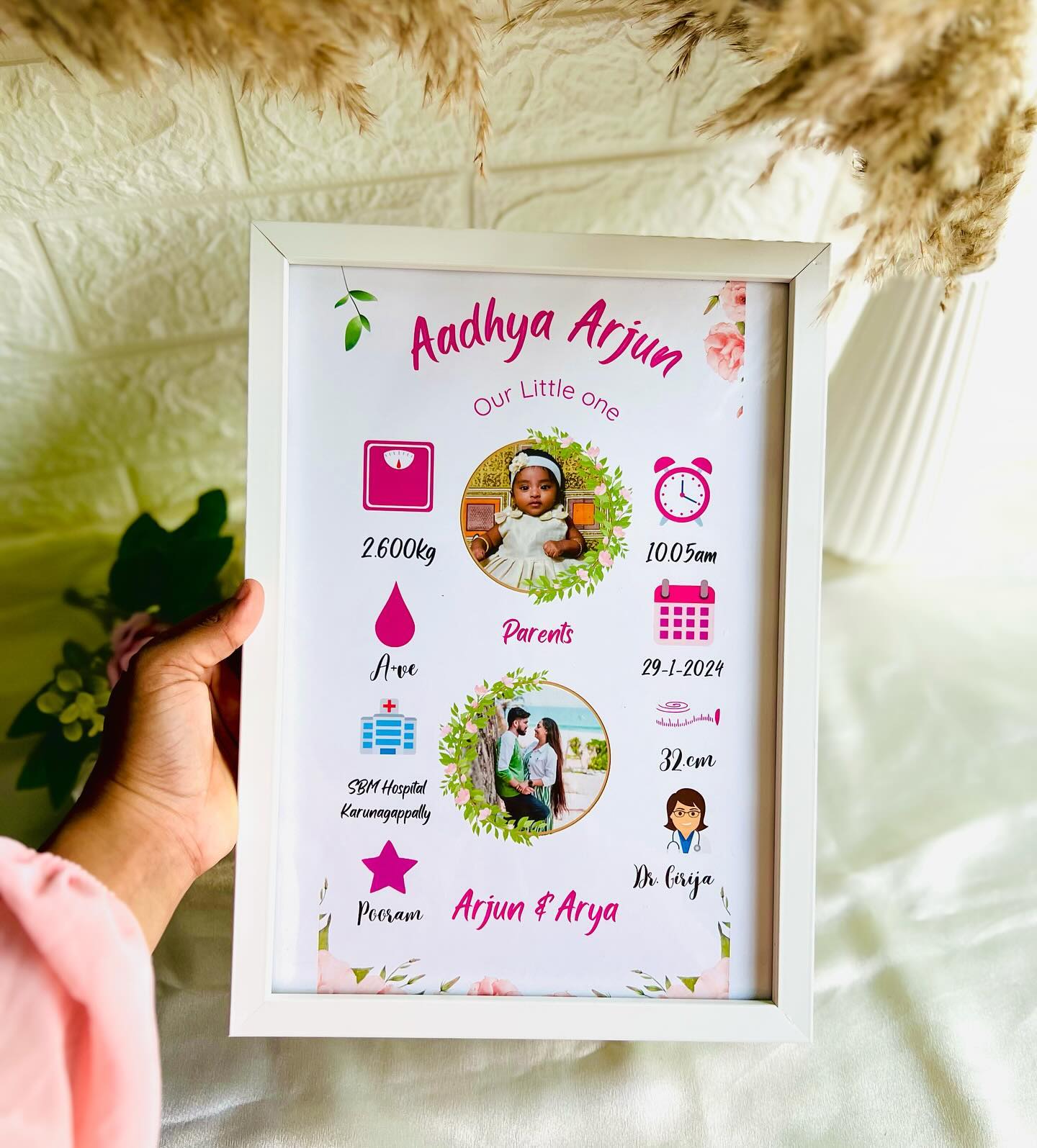 A custom framed birth-stats print with the baby's name, photo, weight, time, and parents' details.