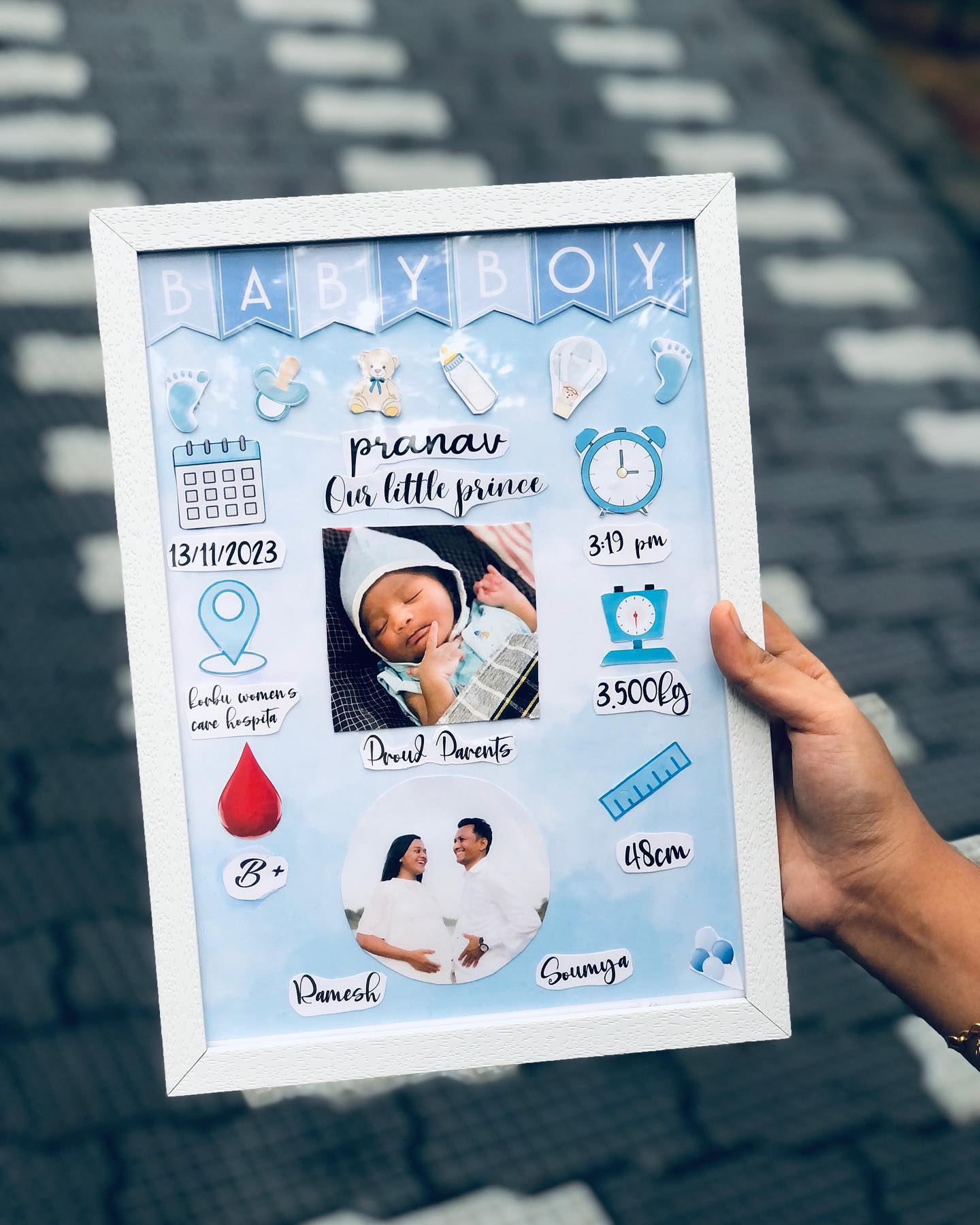 A sky-blue birth announcement frame celebrating a new baby boy with his details and family photos.