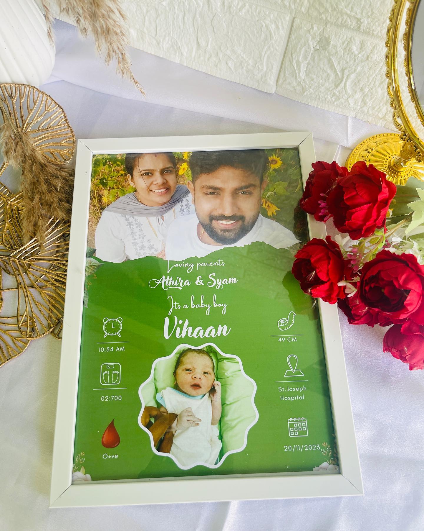 A personalized birth announcement frame naming baby Vihaan, with parent and newborn photos and birth details.