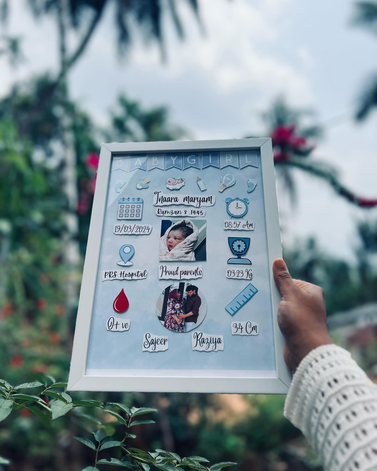 A personalized baby-blue photo frame capturing your newborn's name, birth stats and proud-parent photos.