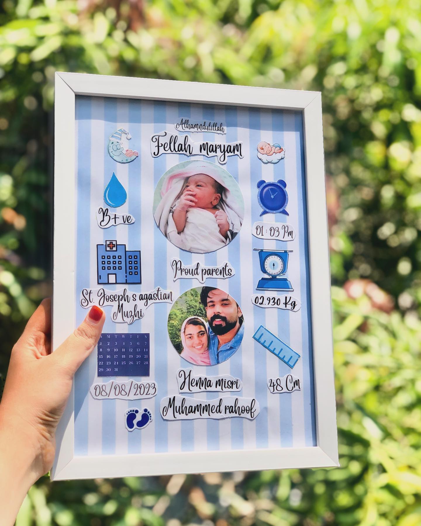A personalized baby-girl milestone frame in soft blue stripes with birth details and proud-parent photos.