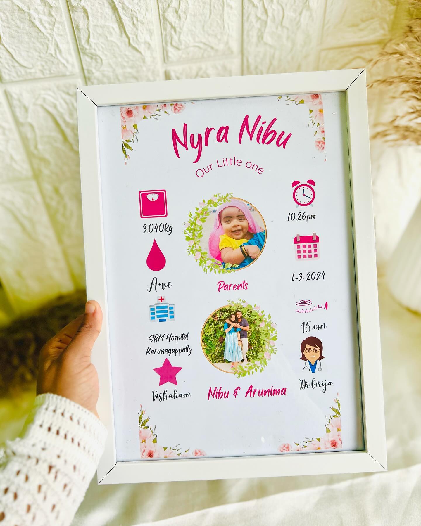 A personalized floral-themed baby milestone frame with name, birth details, and parent photos.