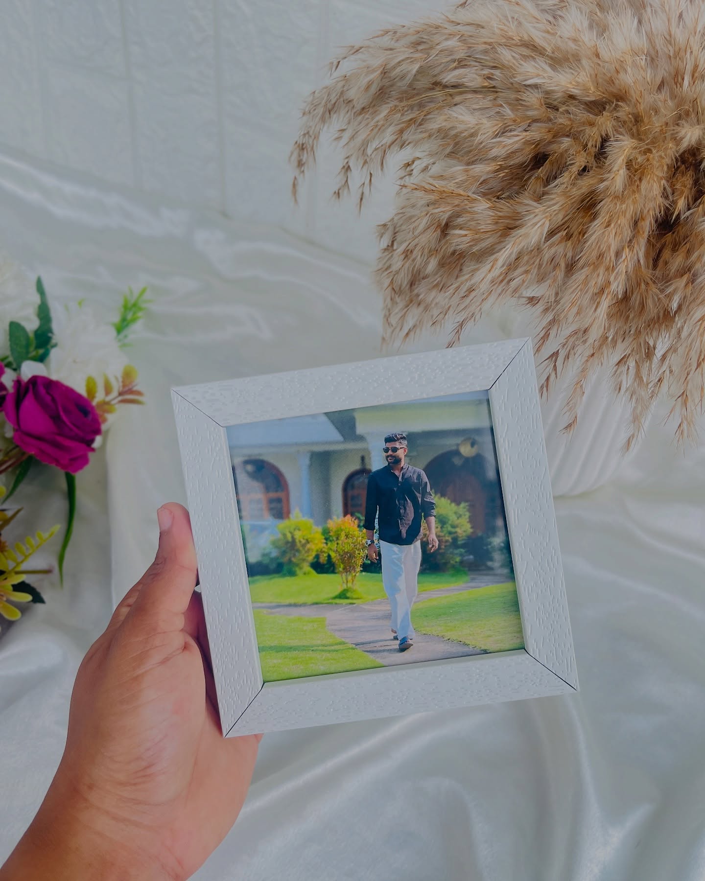 A ring-bound bundle of personalized polaroid-style photo cards topped with a 'Happy Birthday to You' greeting card.