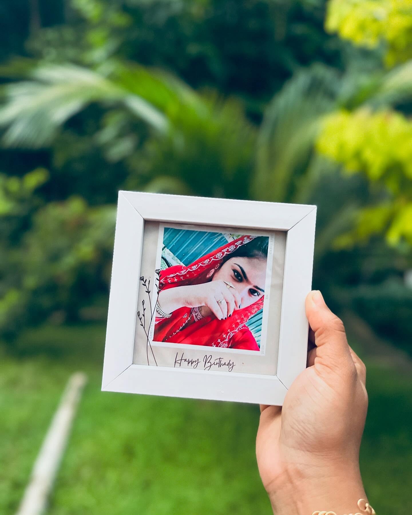 A framed polaroid-style personalized photo print finished with a handwritten Happy Birthday caption.