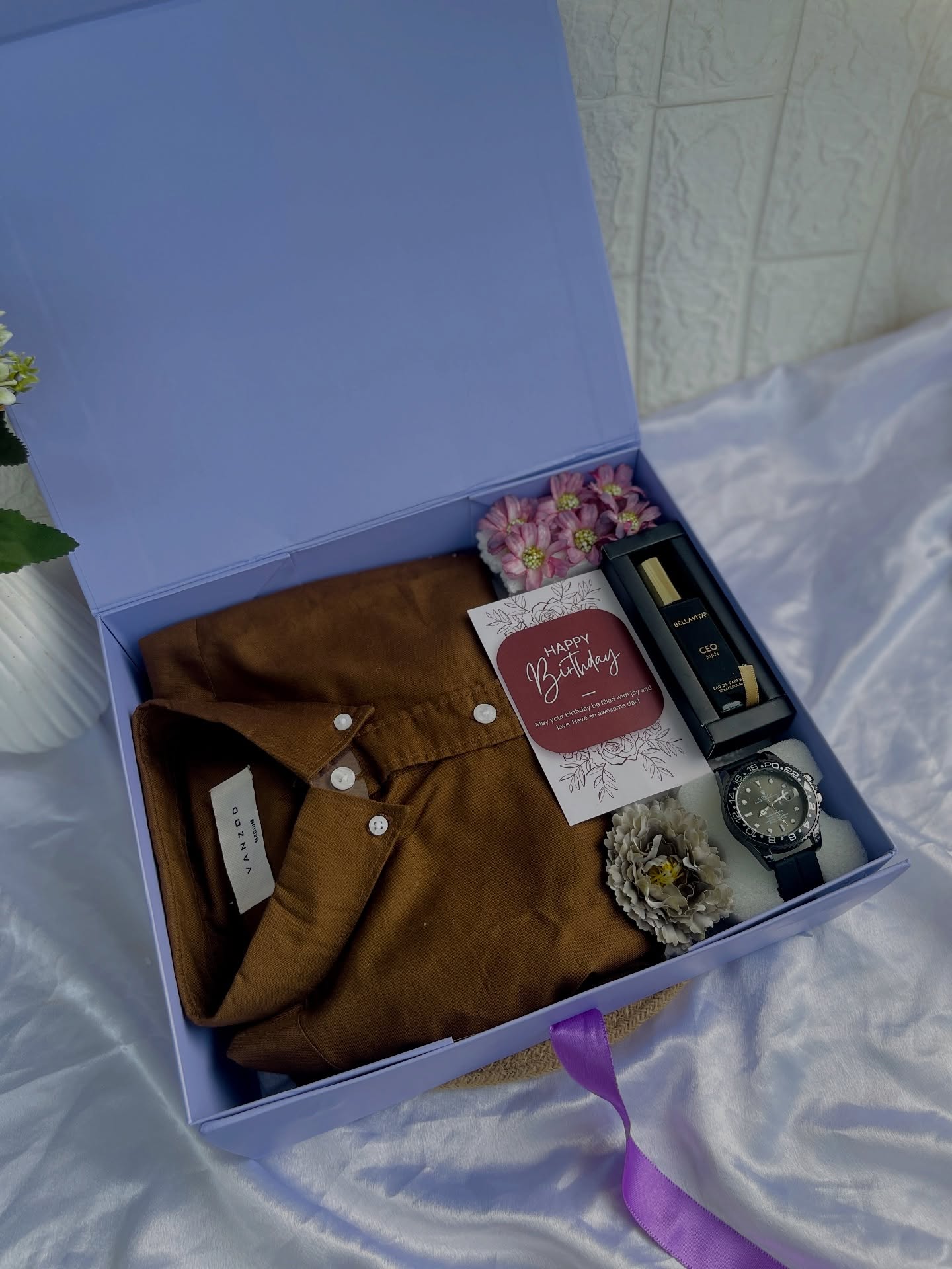 A premium birthday box for him with a linen shirt, wristwatch, cologne, and a handwritten birthday card.
