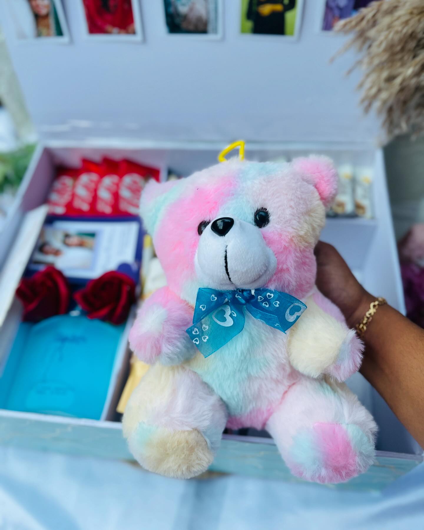 A jam-packed birthday hamper with photo strips, a teddy, perfume, roses, and a chocolate feast.