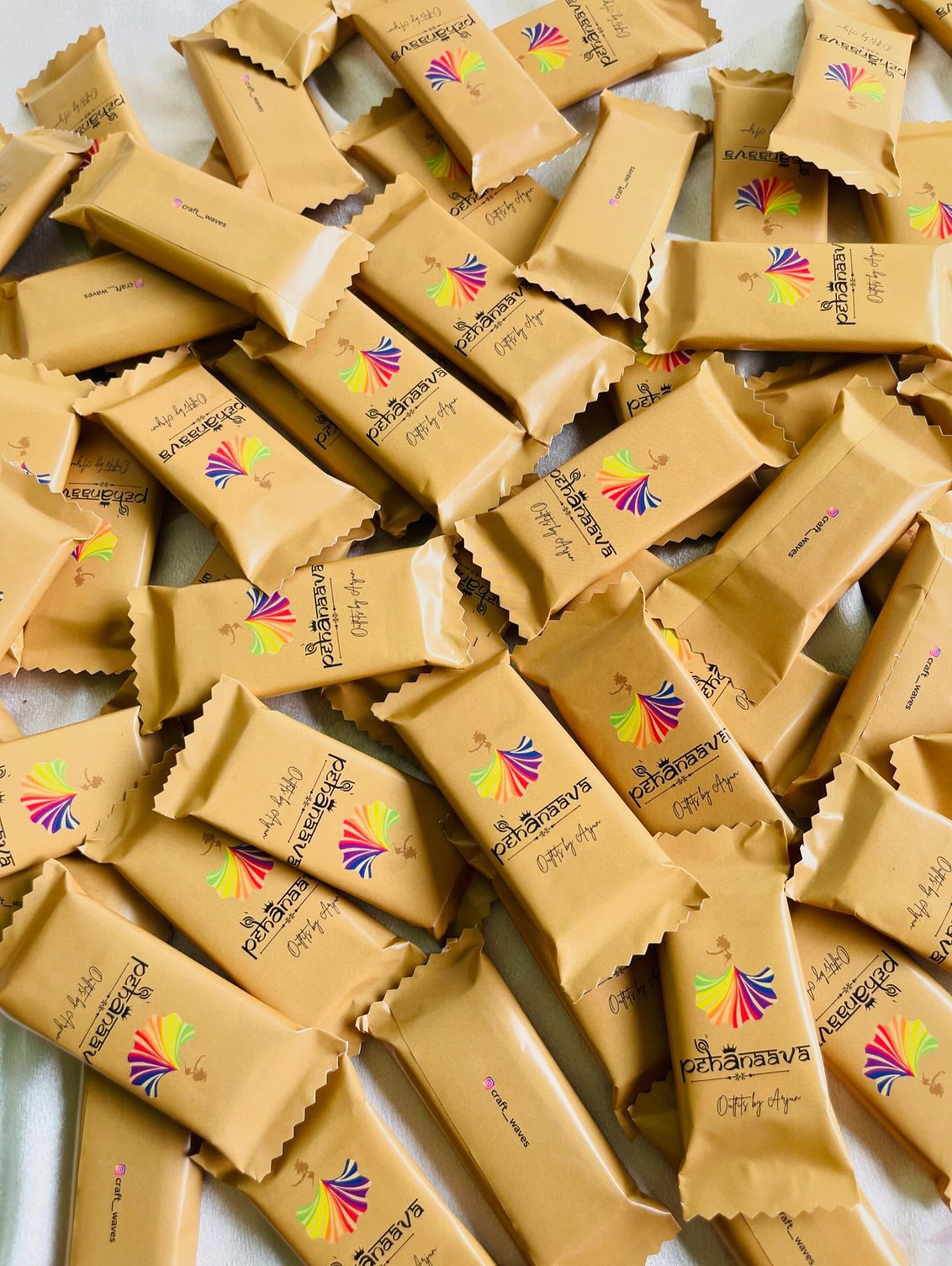 A generous batch of custom-wrapped chocolate bars, ideal as branded corporate or event giveaways.