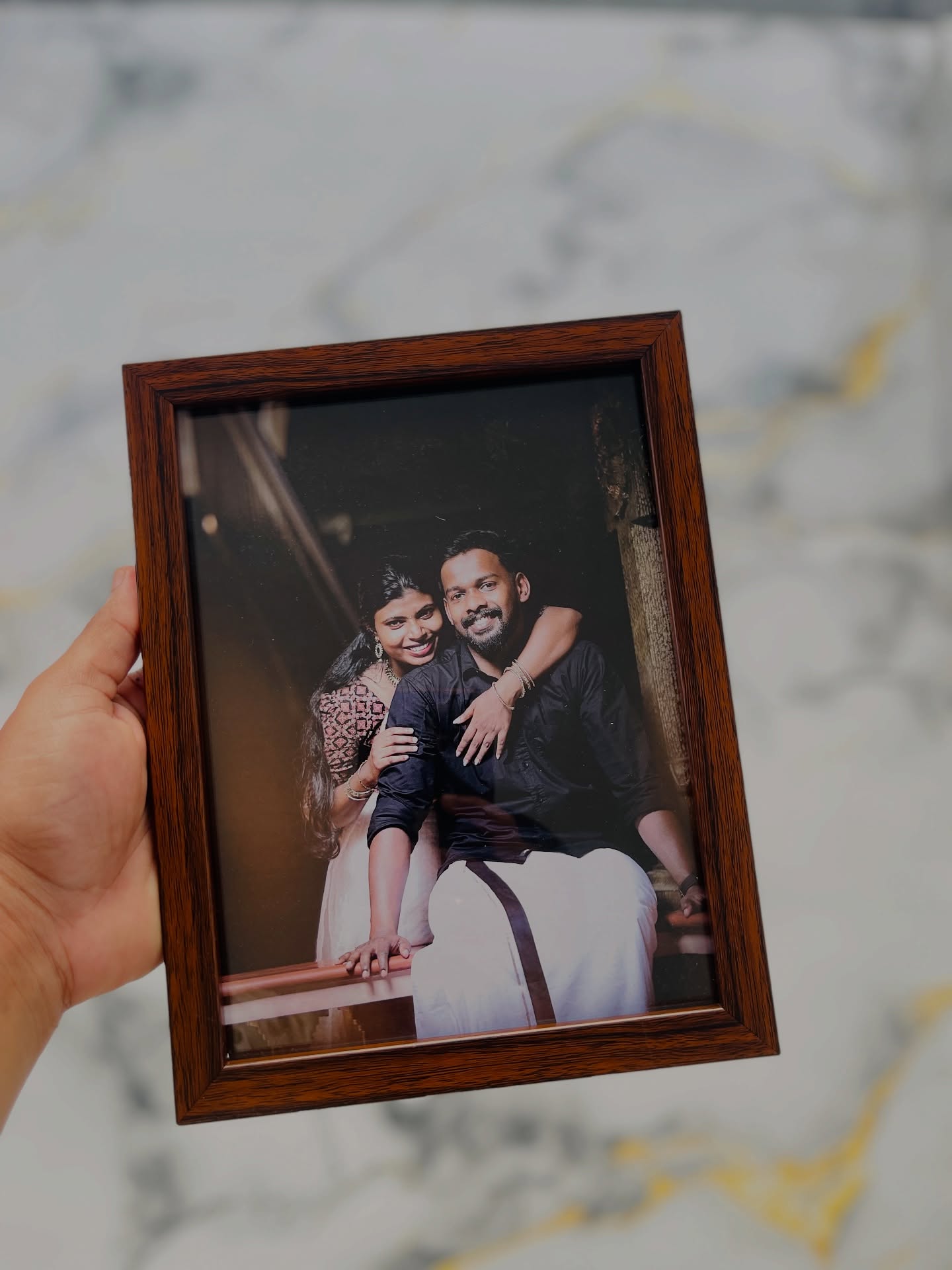 A warm walnut-toned wooden frame showcasing a candid couple photo, ready to personalize with your own picture.