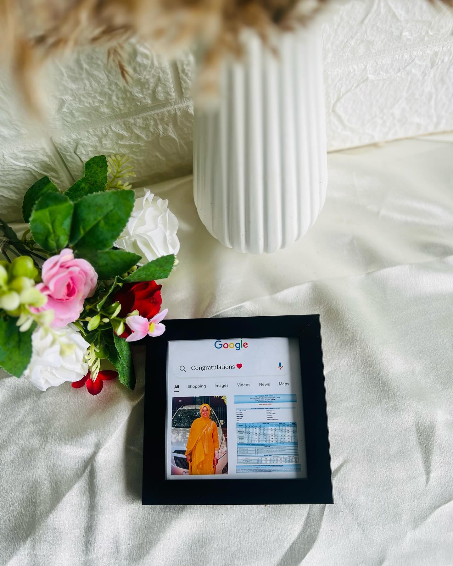 A playful "Google search" style framed print celebrating an exam result with a personal photo.