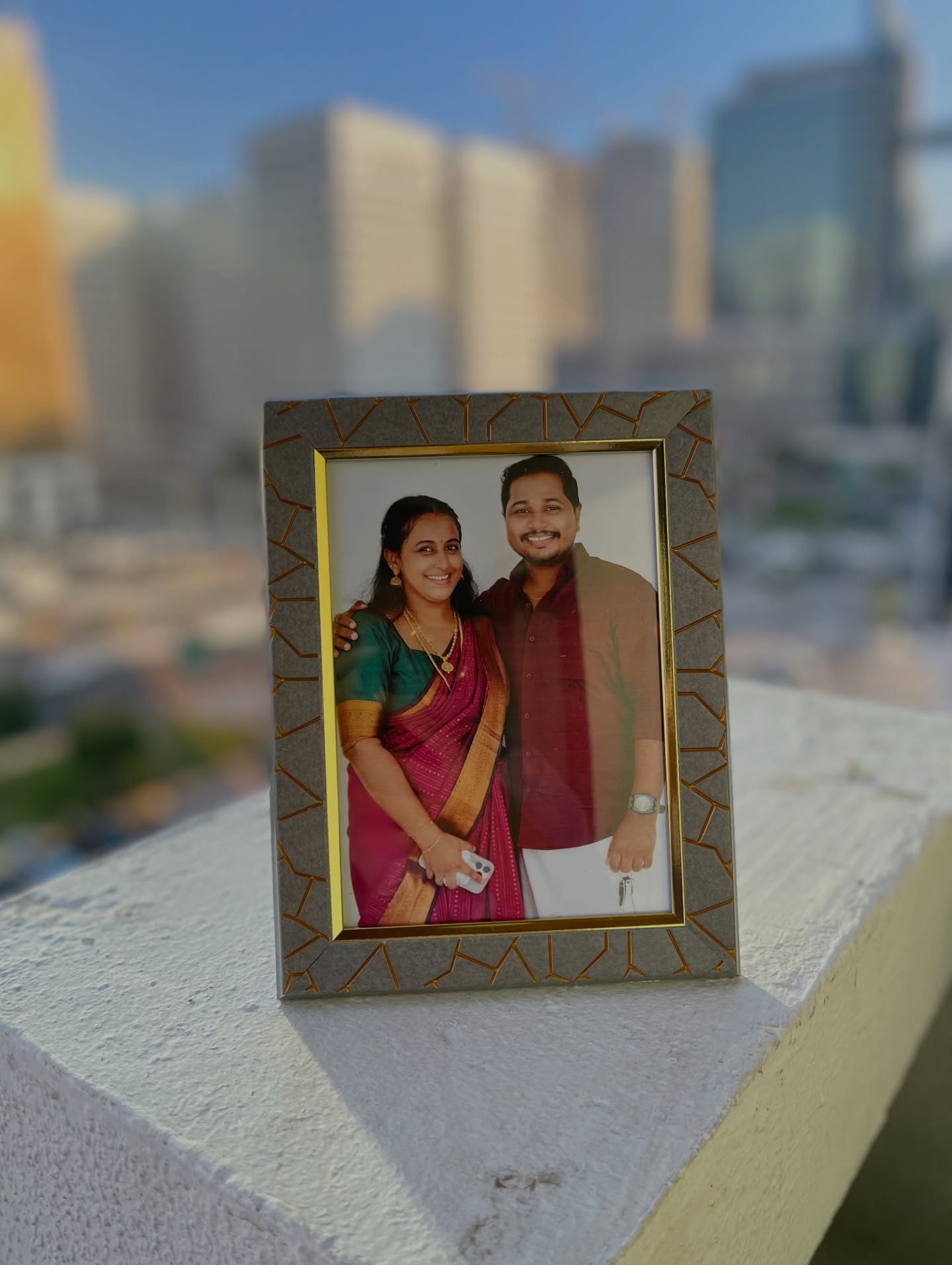 A framed couple photo in a textured gold-trimmed frame, a simple personalized anniversary keepsake.