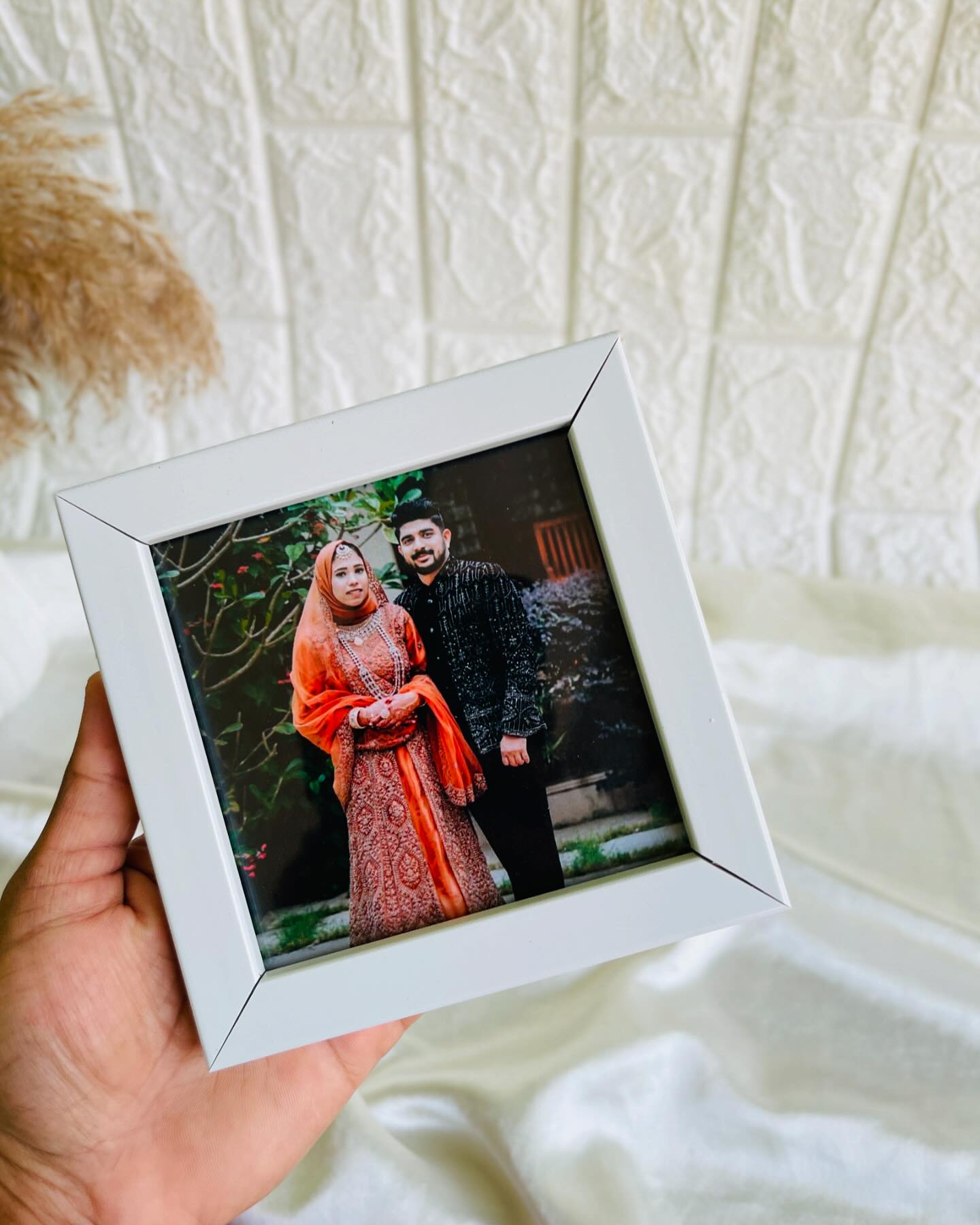 A white photo frame personalized with a couple's portrait, ready to gift as a standalone keepsake.