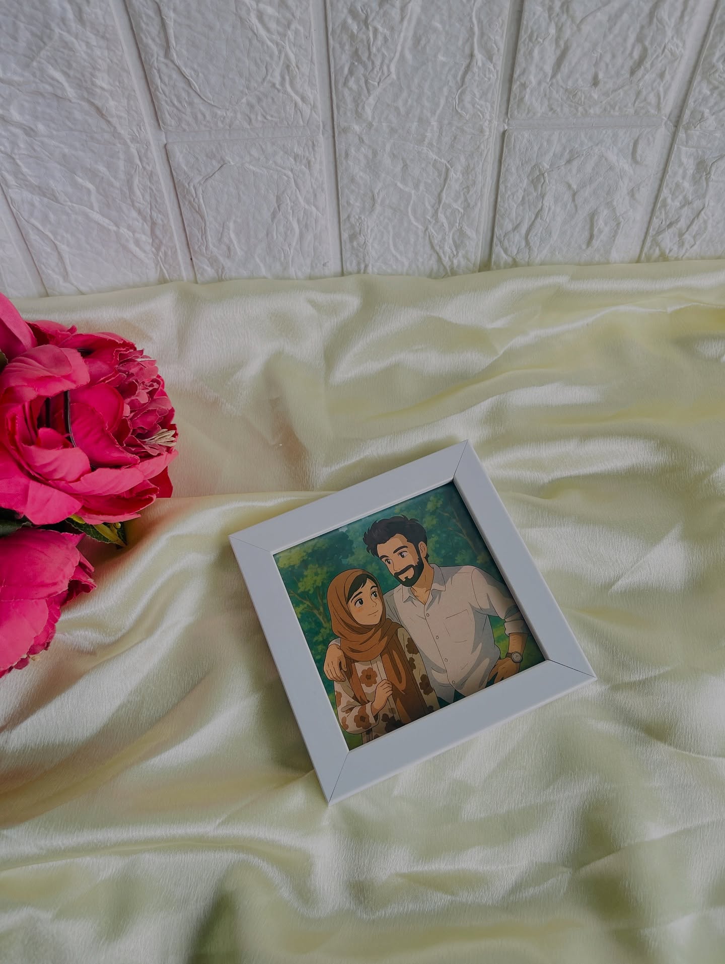 A hand-illustrated couple portrait in a soft white frame, styled with fresh pink roses for a heartfelt surprise.
