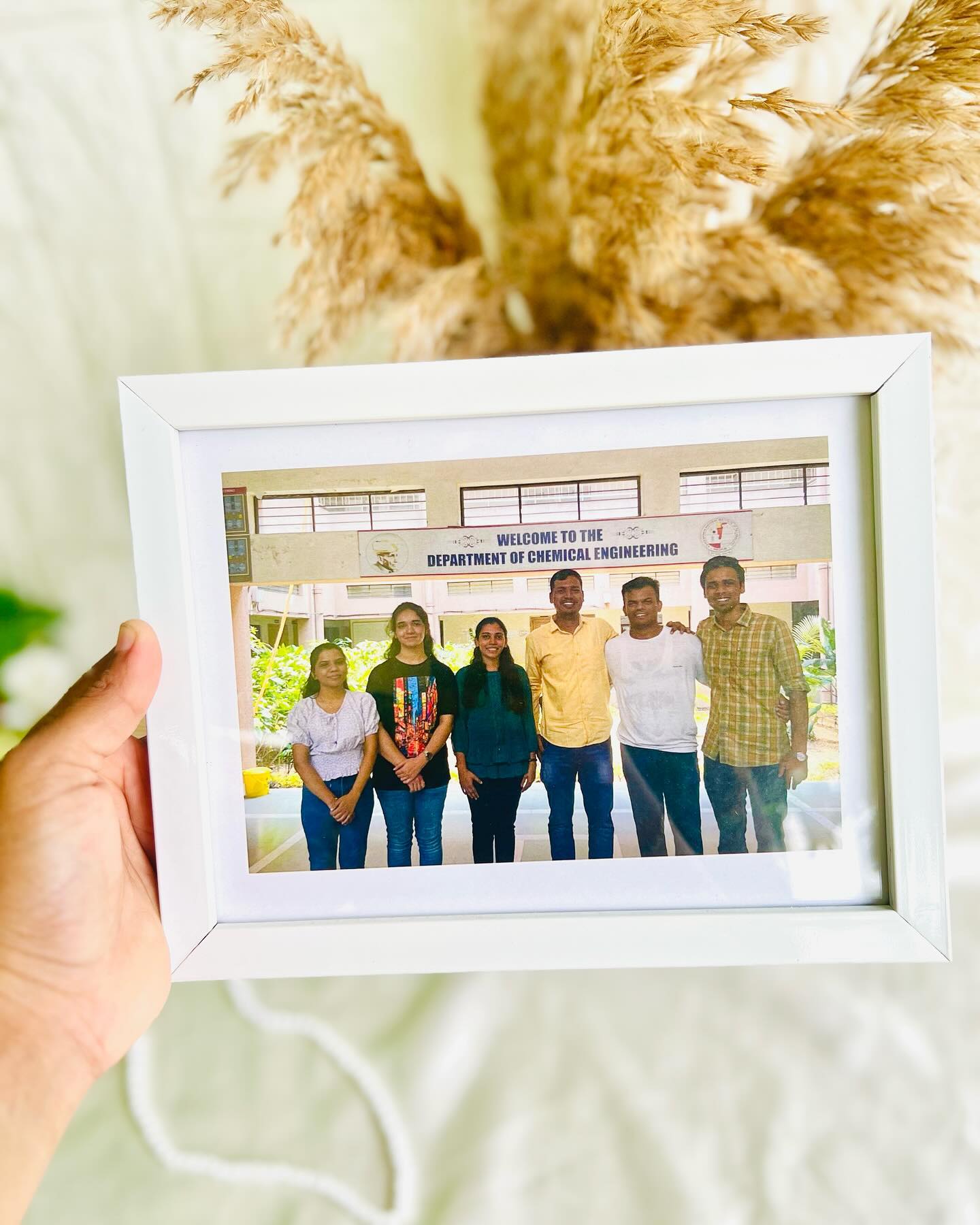A simple white wooden frame personalized with a treasured group photo.