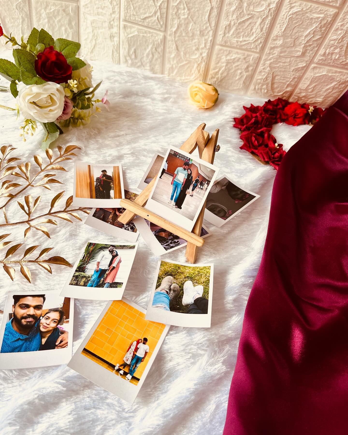 A curated set of personalized polaroid-style photo prints displayed on a mini wooden easel, perfect for gifting cherished couple memories.