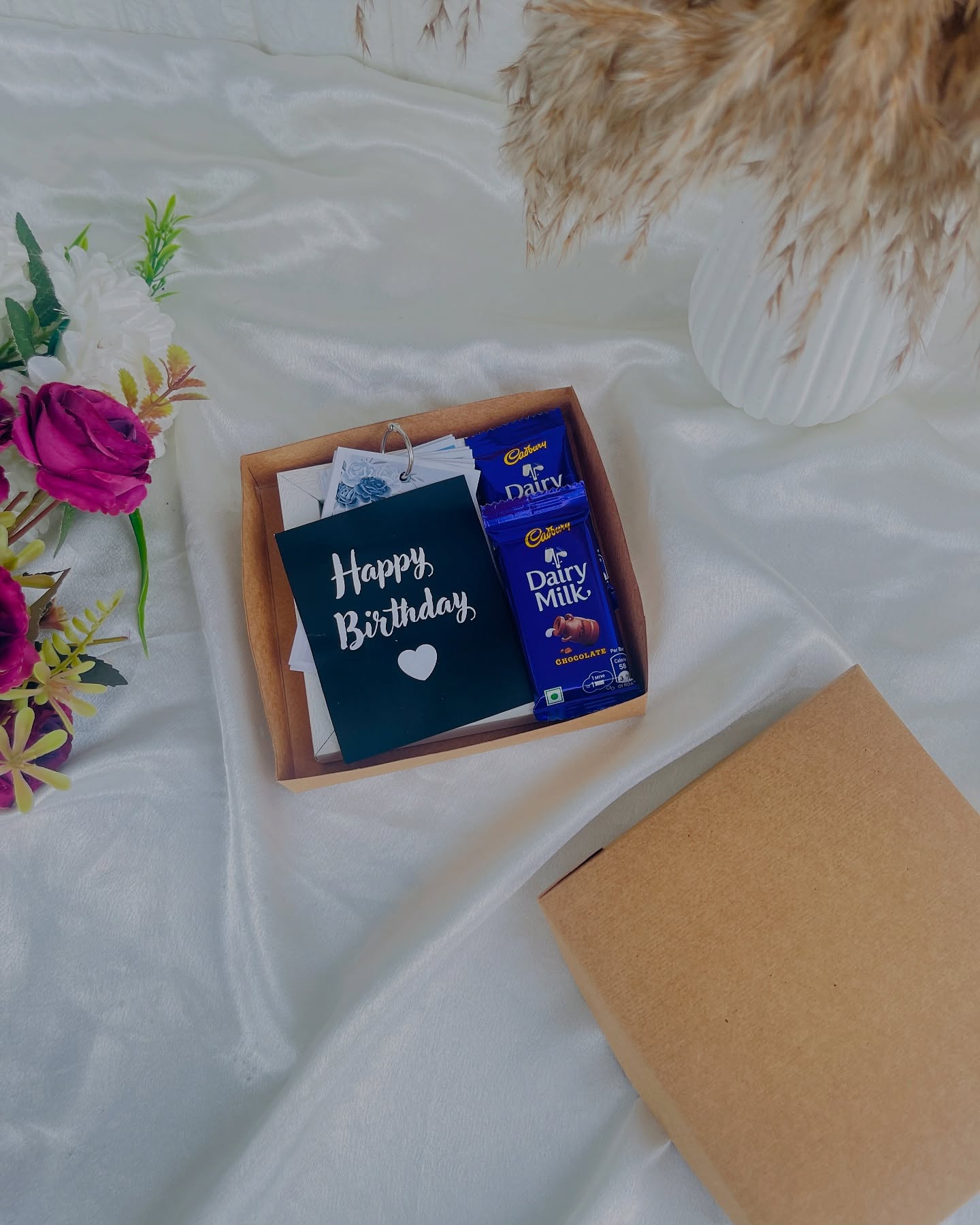 A simple kraft gift tray with a Happy Birthday card and Cadbury Dairy Milk chocolate bars.