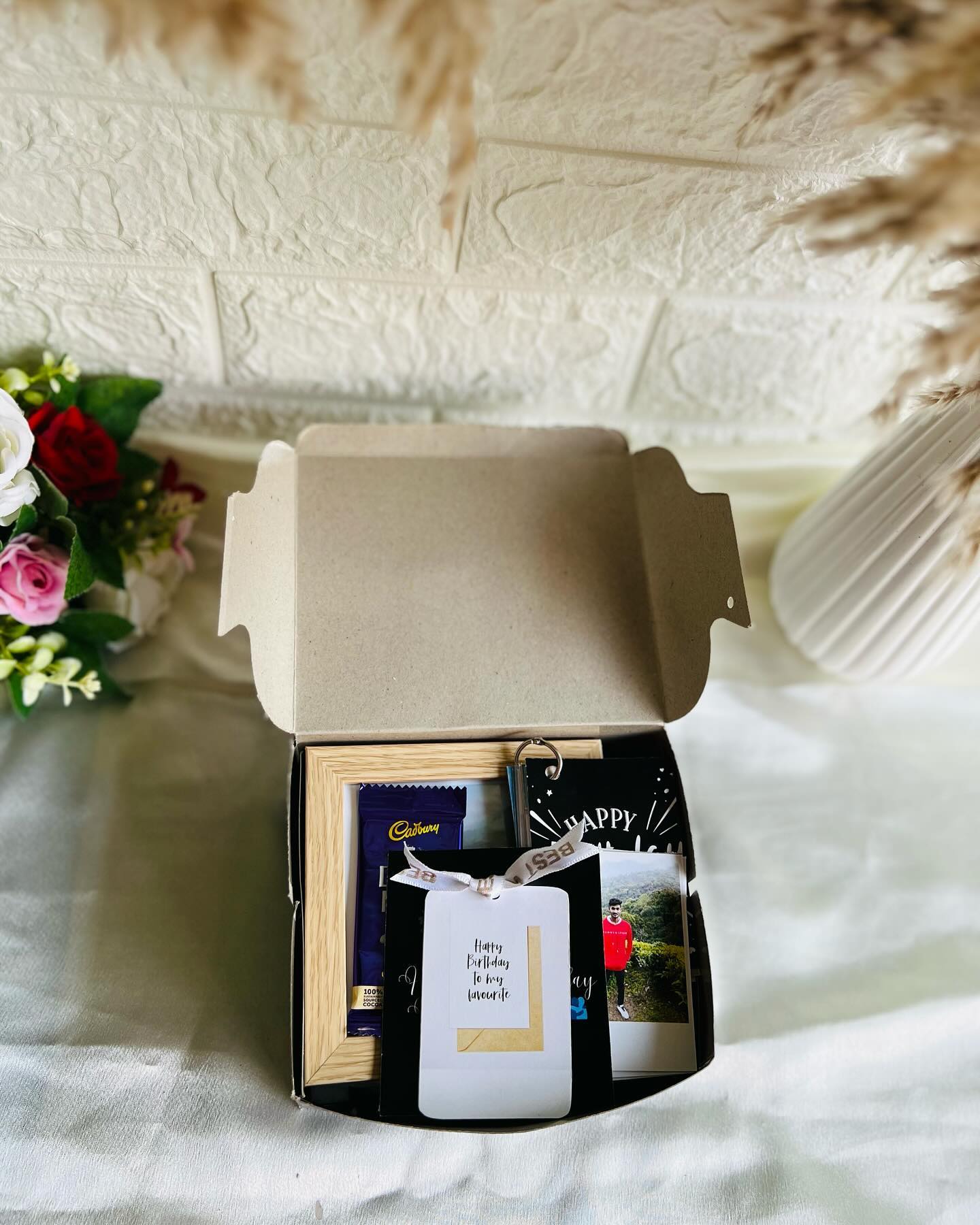A cozy birthday surprise box with Cadbury chocolate, printed photo cards, and a heartfelt birthday note.