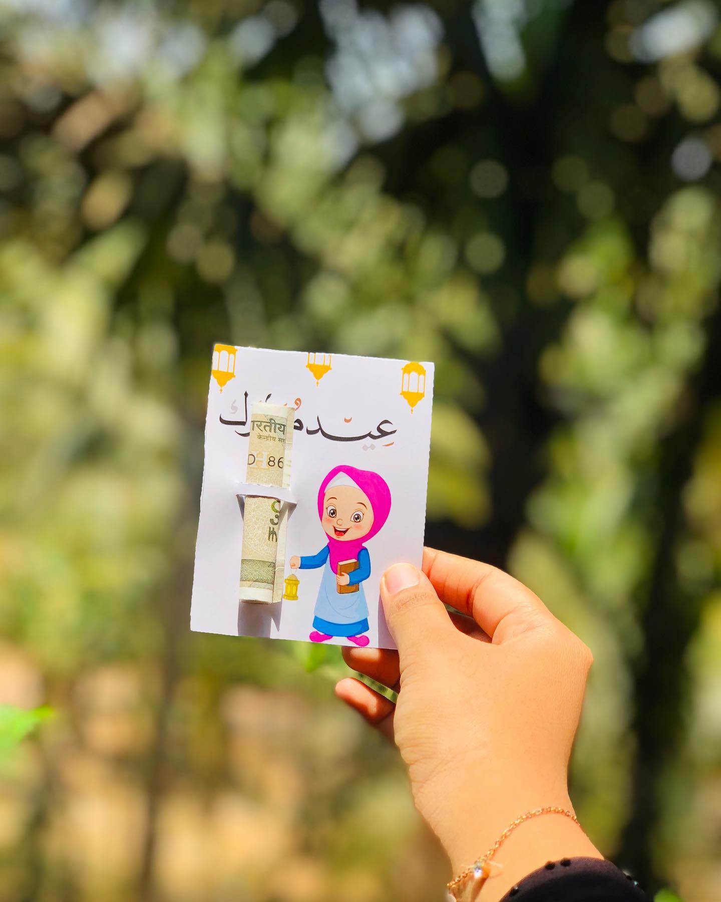 A charming Eid greeting card with a cash note tucked into a cute illustrated pocket, ready to gift as Eidi.