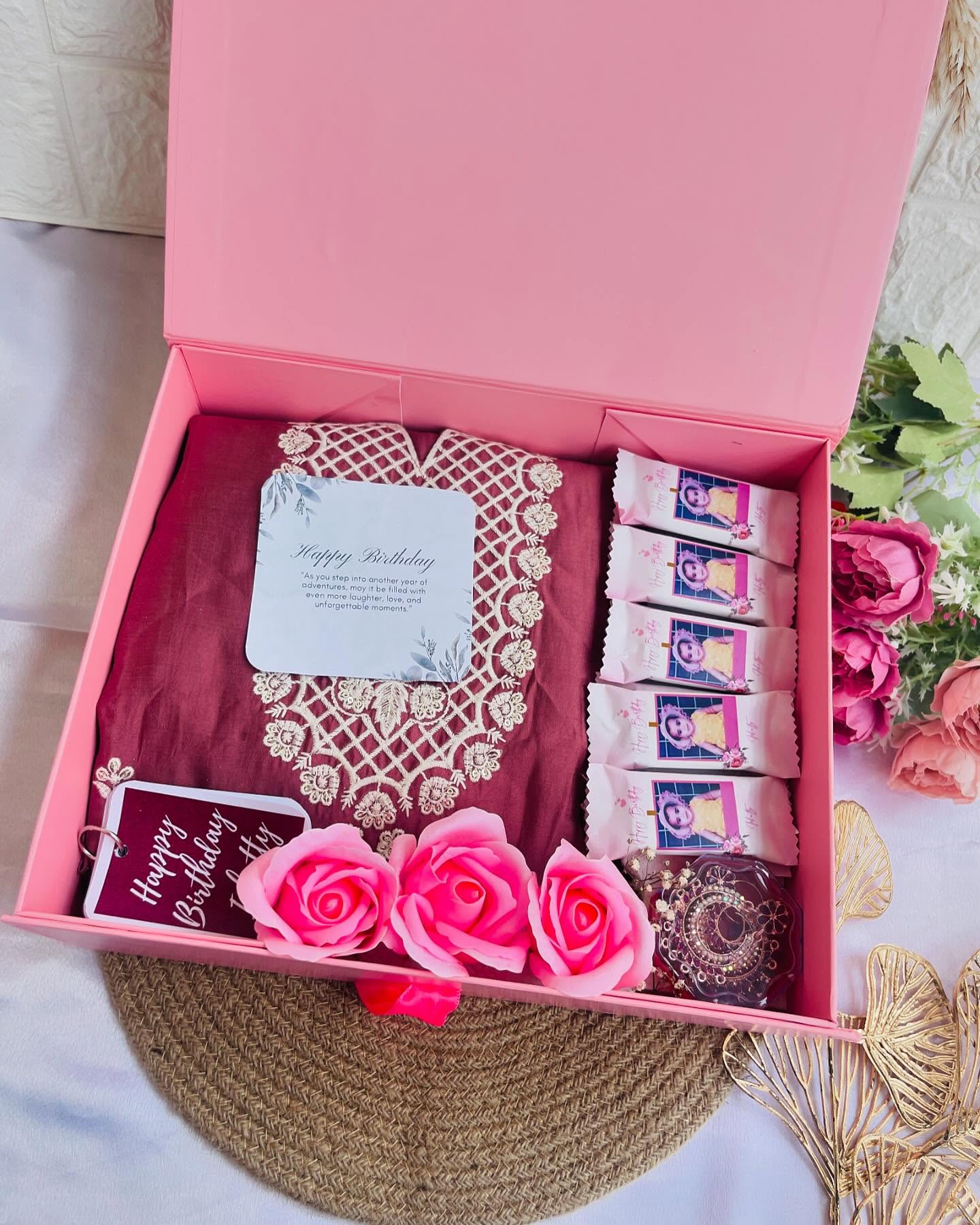 A maroon embroidered kurta paired with photo-printed cookies, bangles, roses, and a personalised birthday tag.