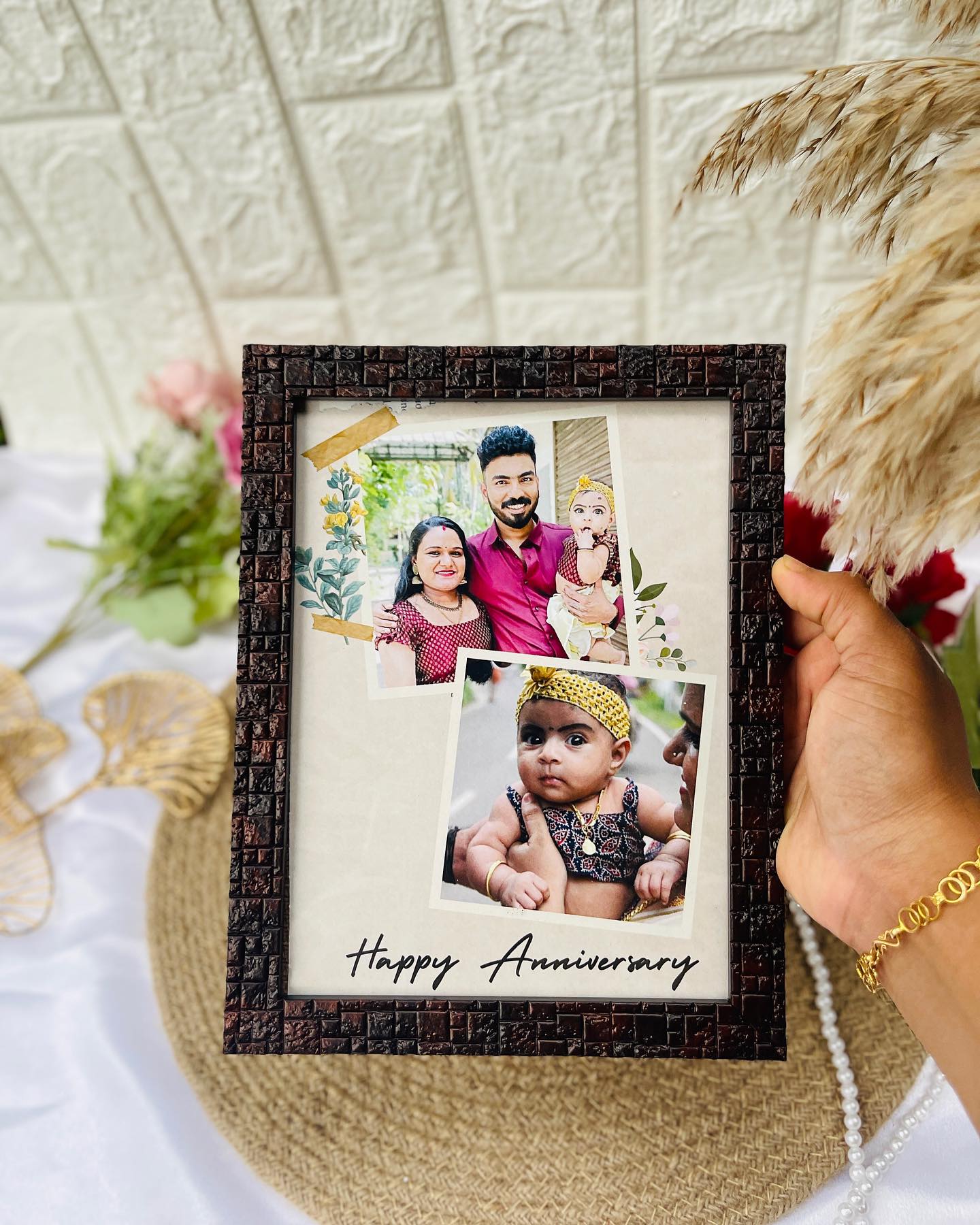 A personalized 'Happy Anniversary' photo frame collage celebrating the couple and their little one.