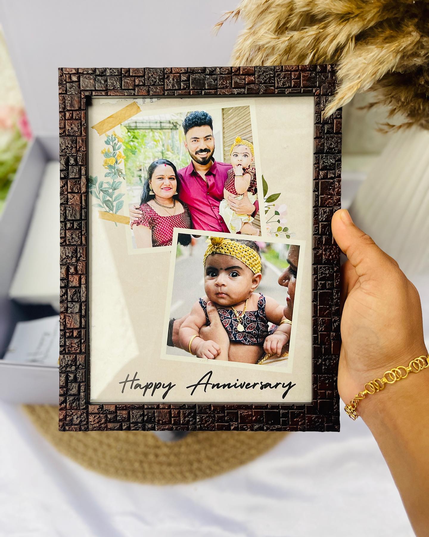 A textured wooden-look photo frame layered with personalized family photos and a handwritten anniversary note.