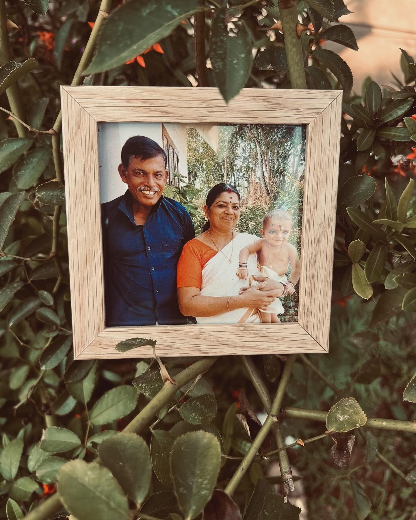A warm wooden mini photo frame personalized with a cherished family portrait.