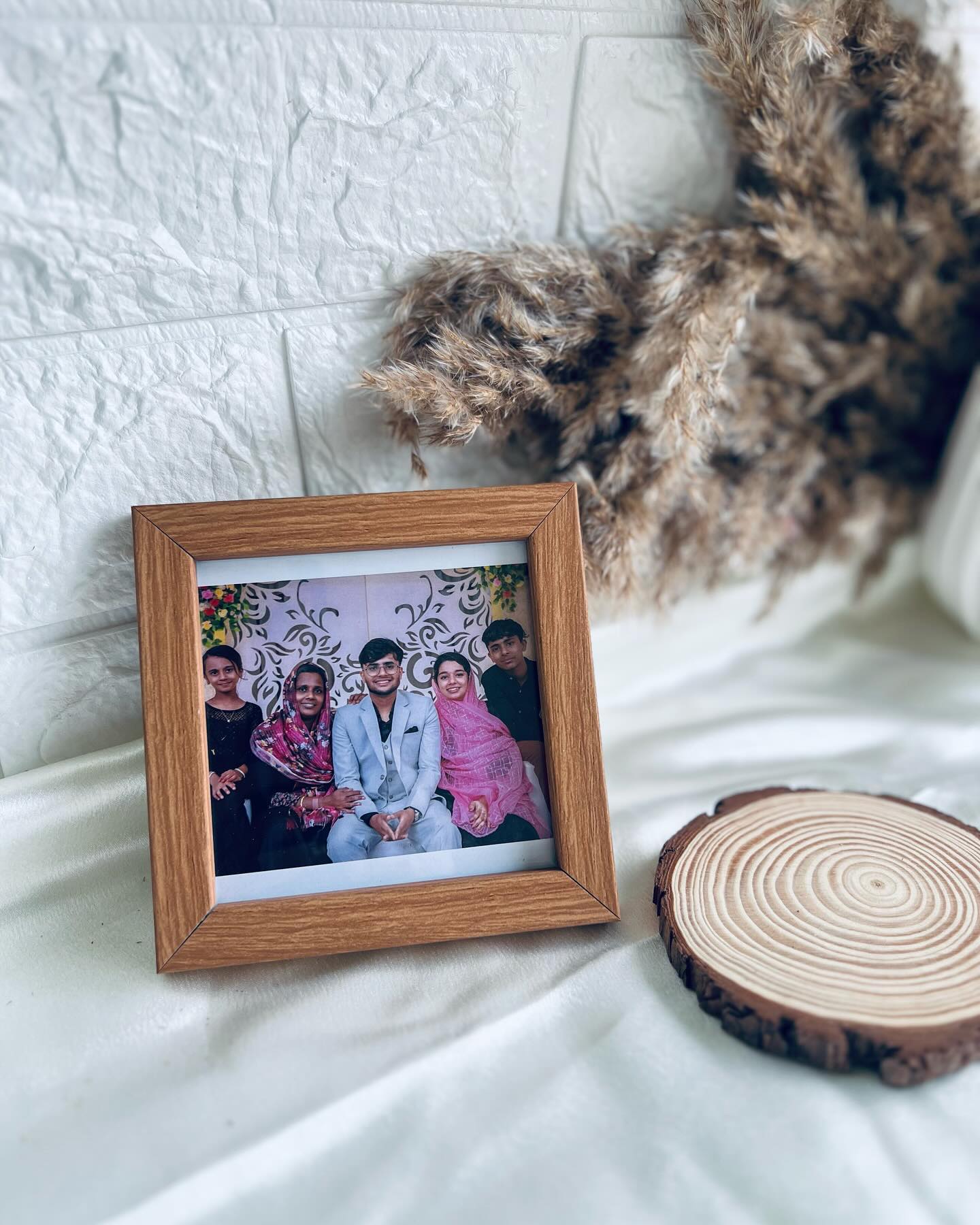 A warm wooden-framed family photo, a simple and thoughtful keepsake for loved ones.