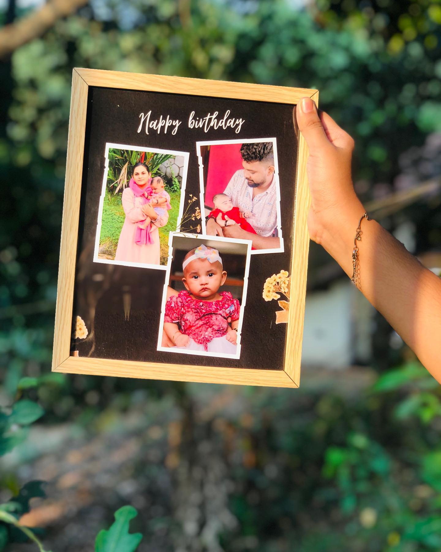 A wooden photo frame collage printed with cherished family photos and a Happy Birthday message.