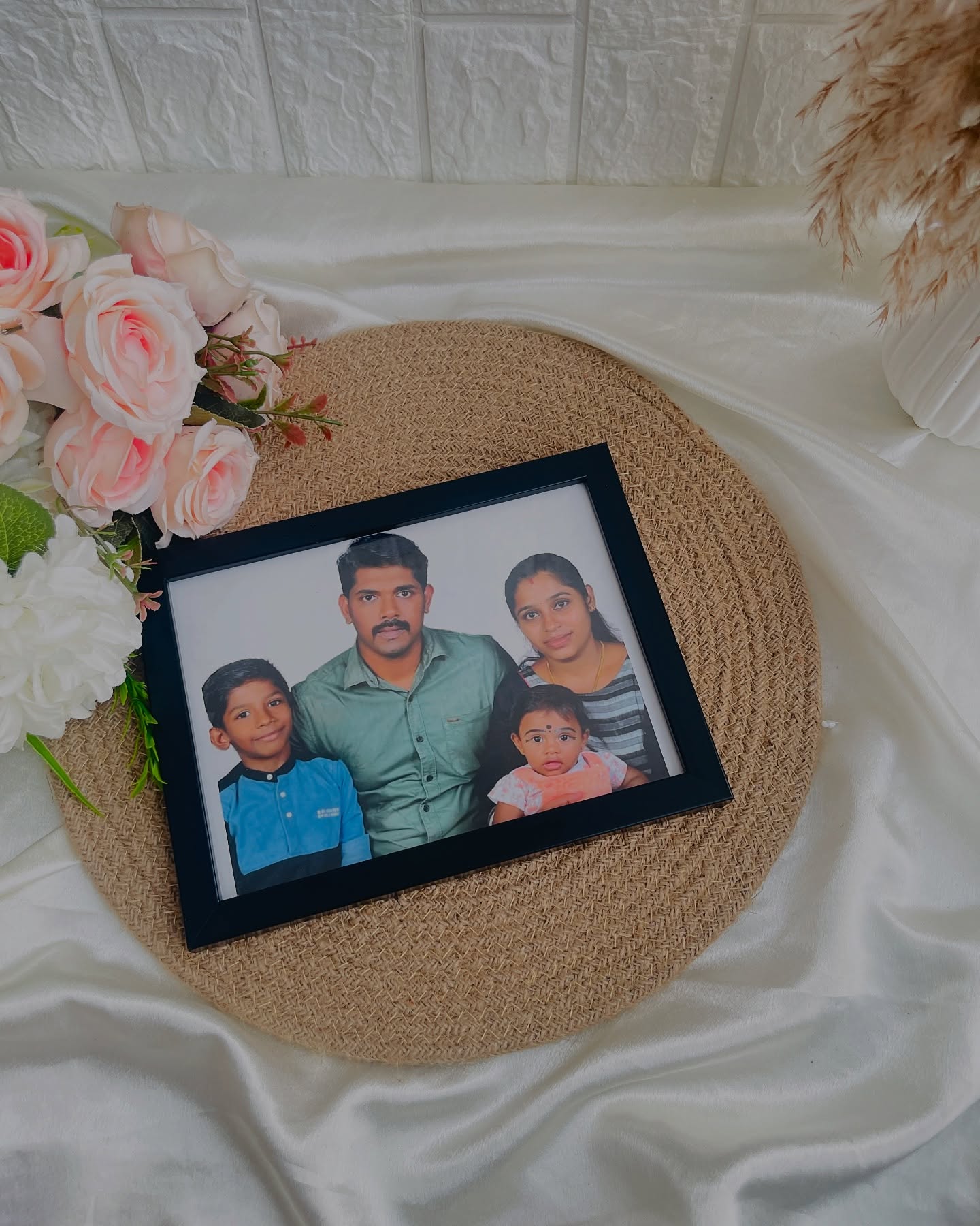 A simple black-framed family portrait, ready to gift as a heartfelt keepsake.