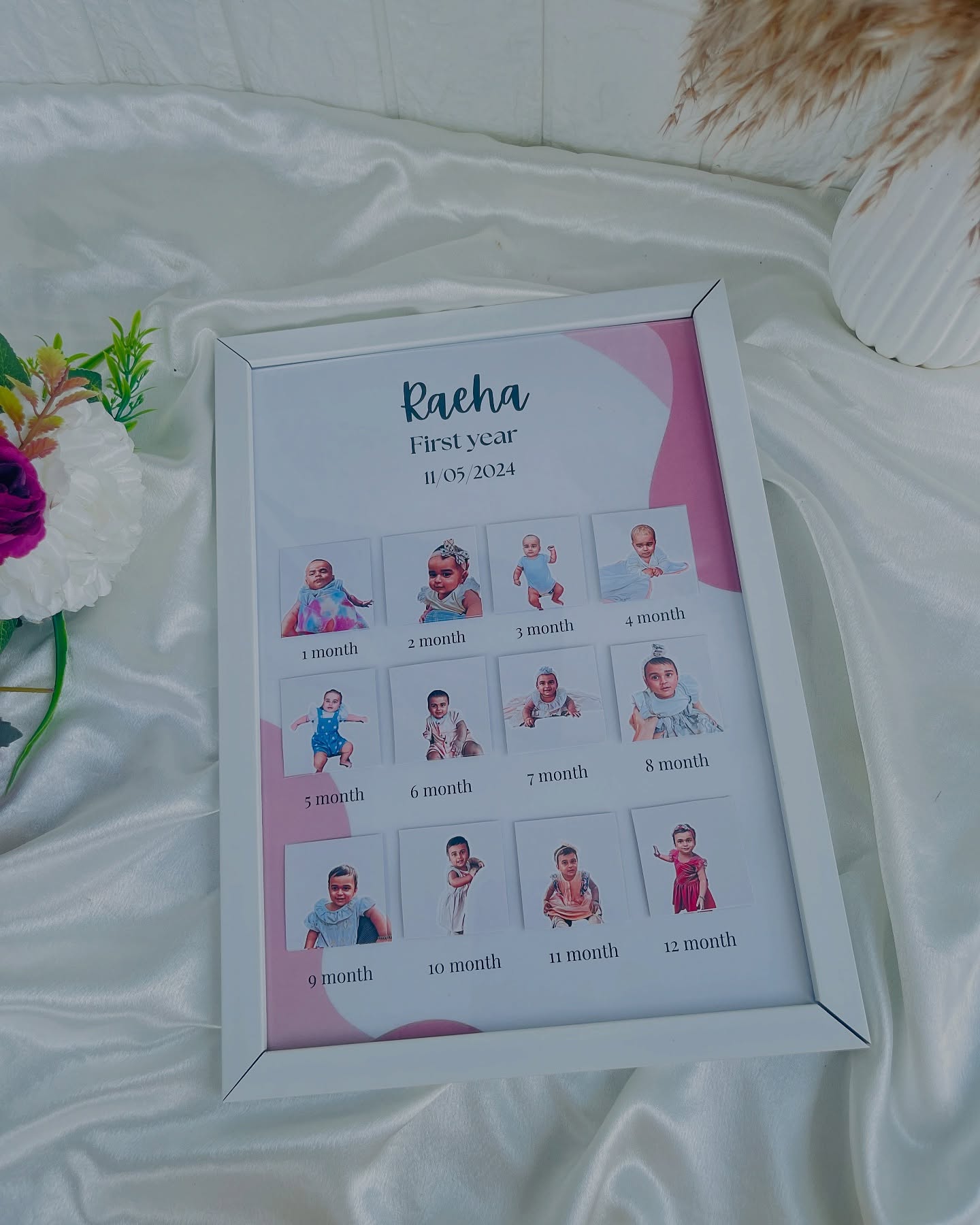 A white photo frame charting a baby's first year with a labelled photo for every month.