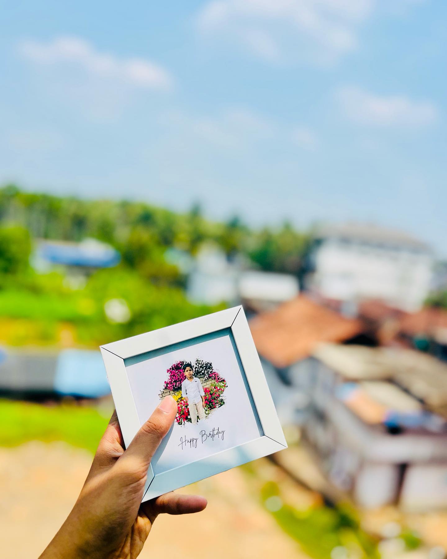 A personalized square photo frame with a custom edited photo set inside a floral heart and a 'Happy Birthday' caption.