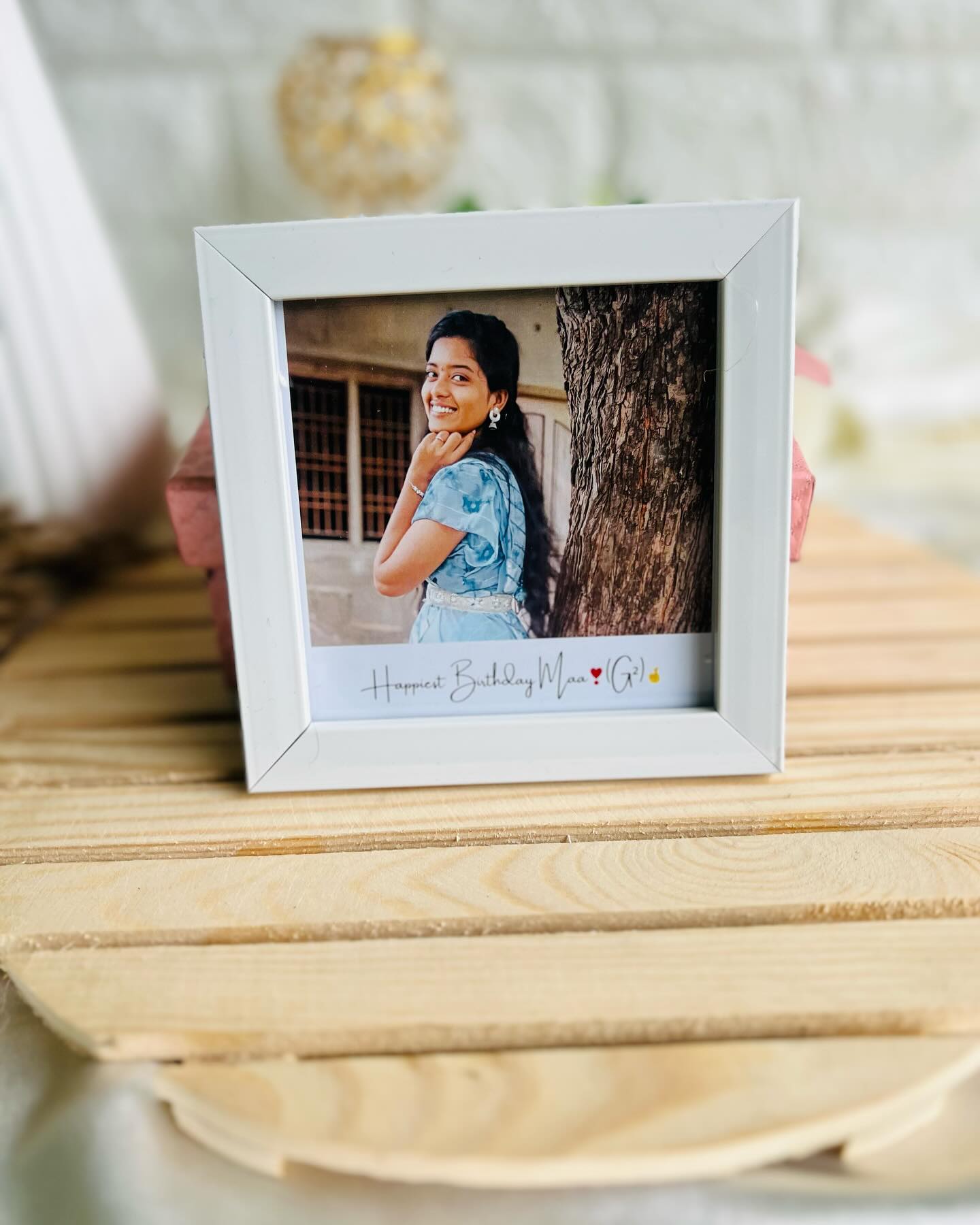 A personalized square photo frame printed with a cherished portrait and a heartfelt 'Happiest Birthday Maa' message.