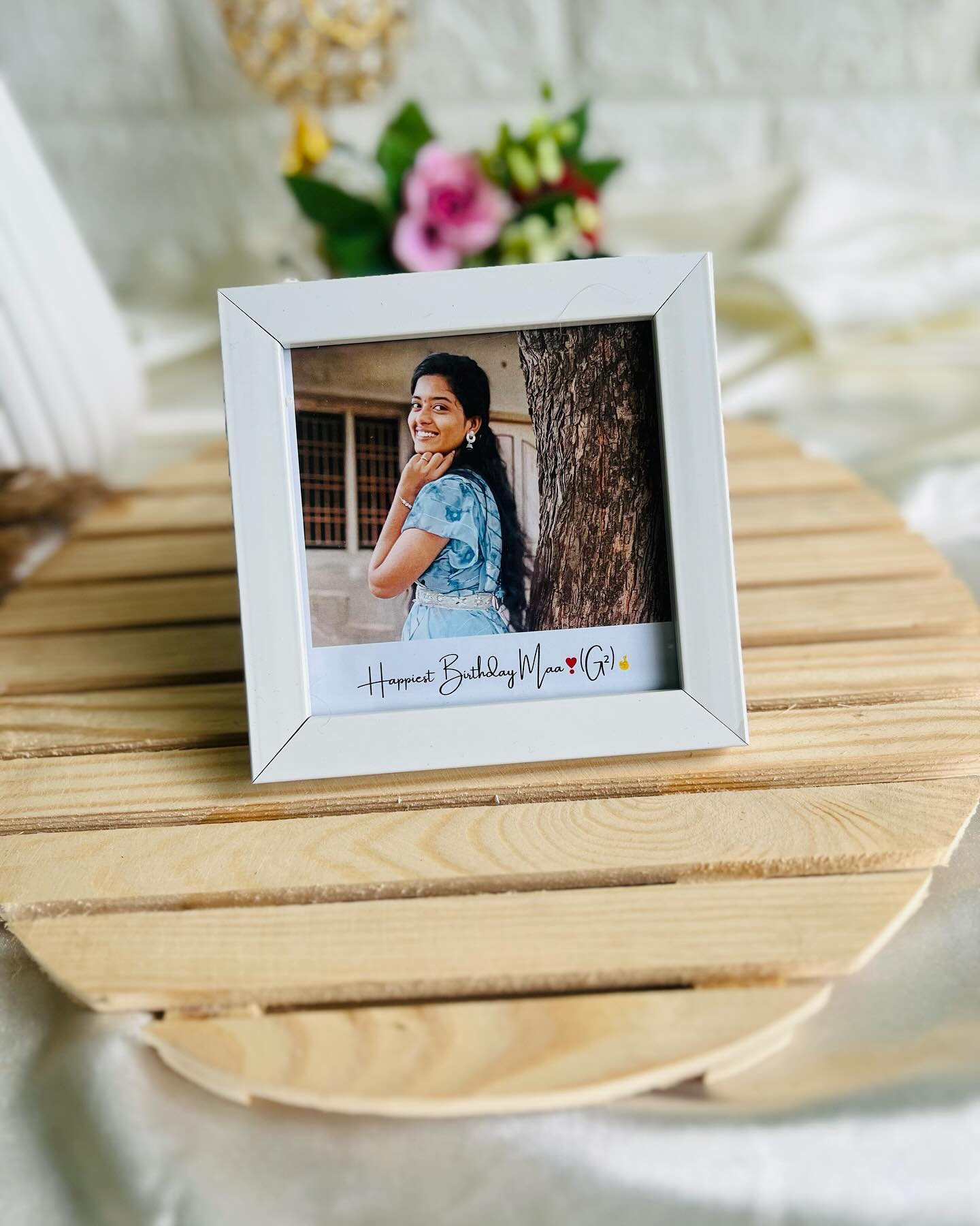 A white tabletop photo frame personalized with a cherished picture and a warm 'Happiest Birthday Maa' message.