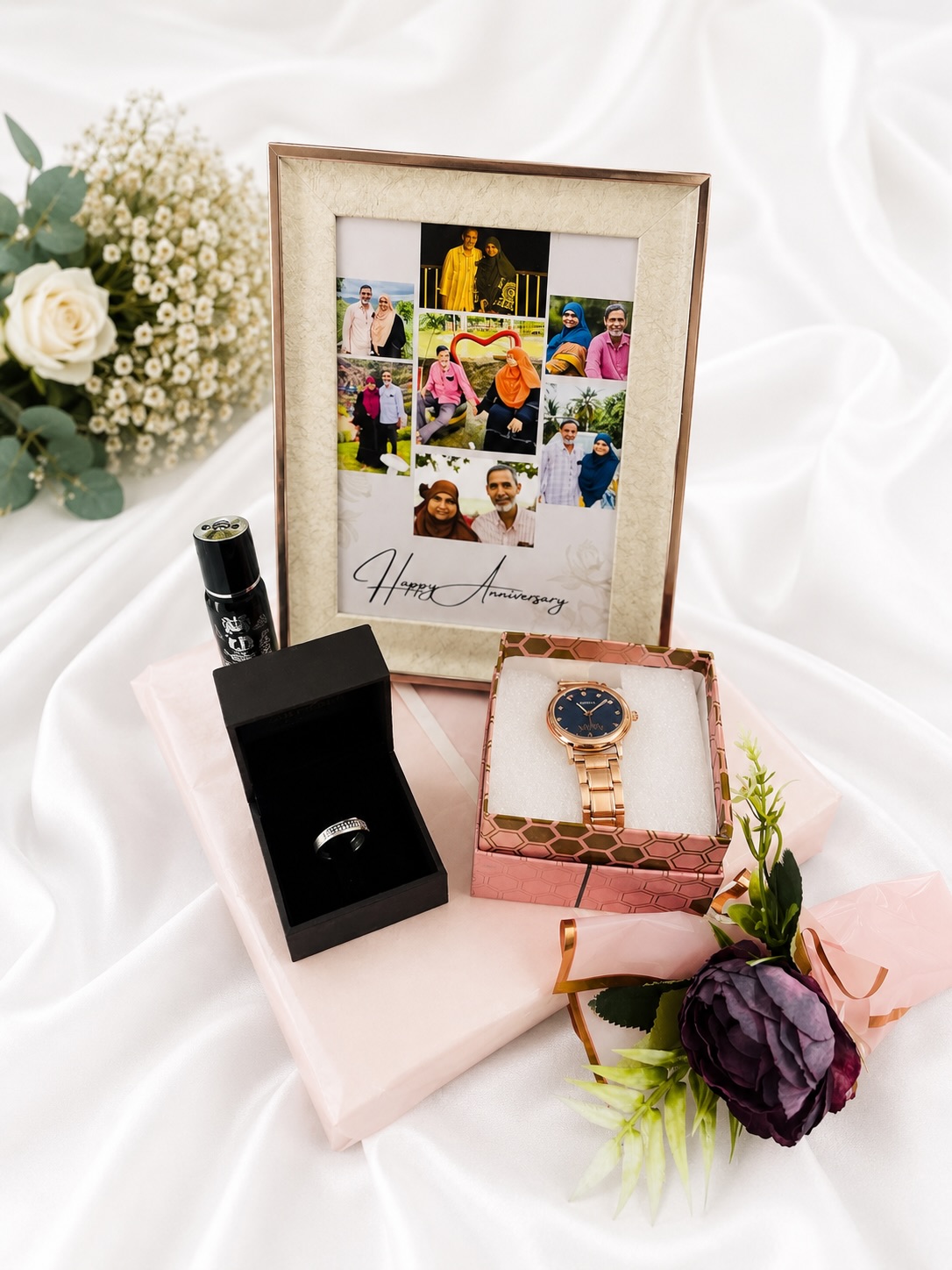 An anniversary gift set with a personalized photo collage frame, a rose gold watch, a ring, and perfume.