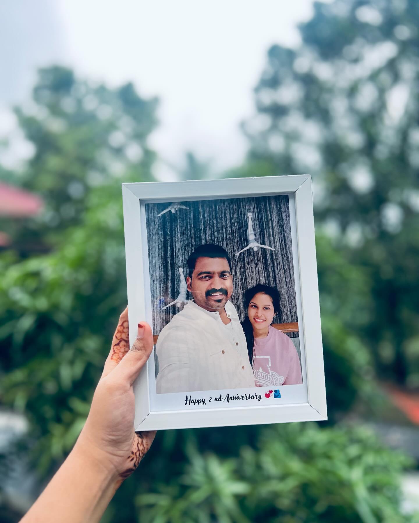 A personalized tabletop photo frame printed with a couple's favourite moment and a custom anniversary message.