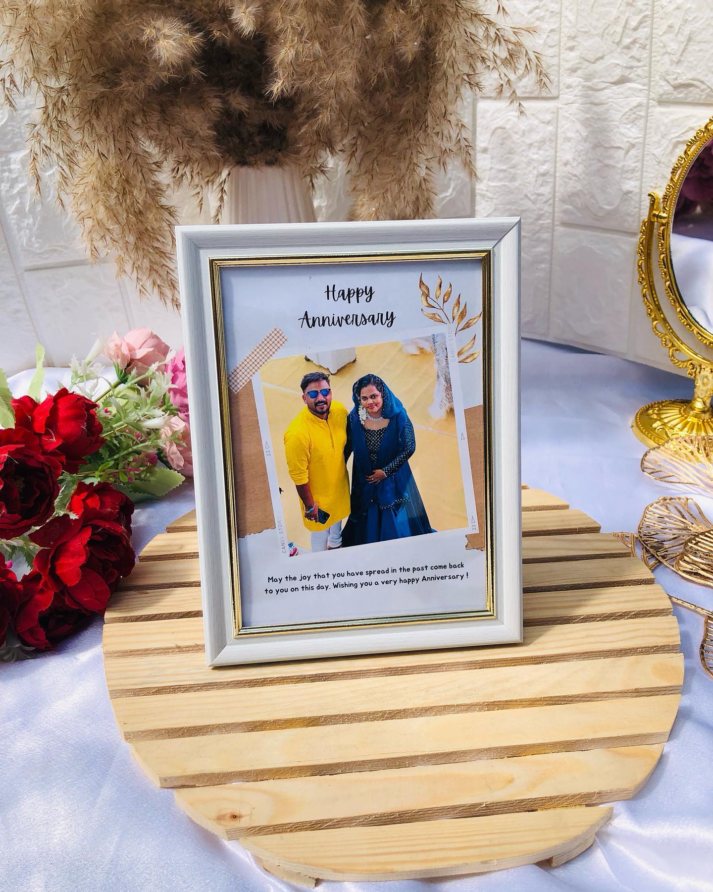 A framed 'Happy Anniversary' keepsake print with a personalized couple photo and a warm anniversary message.