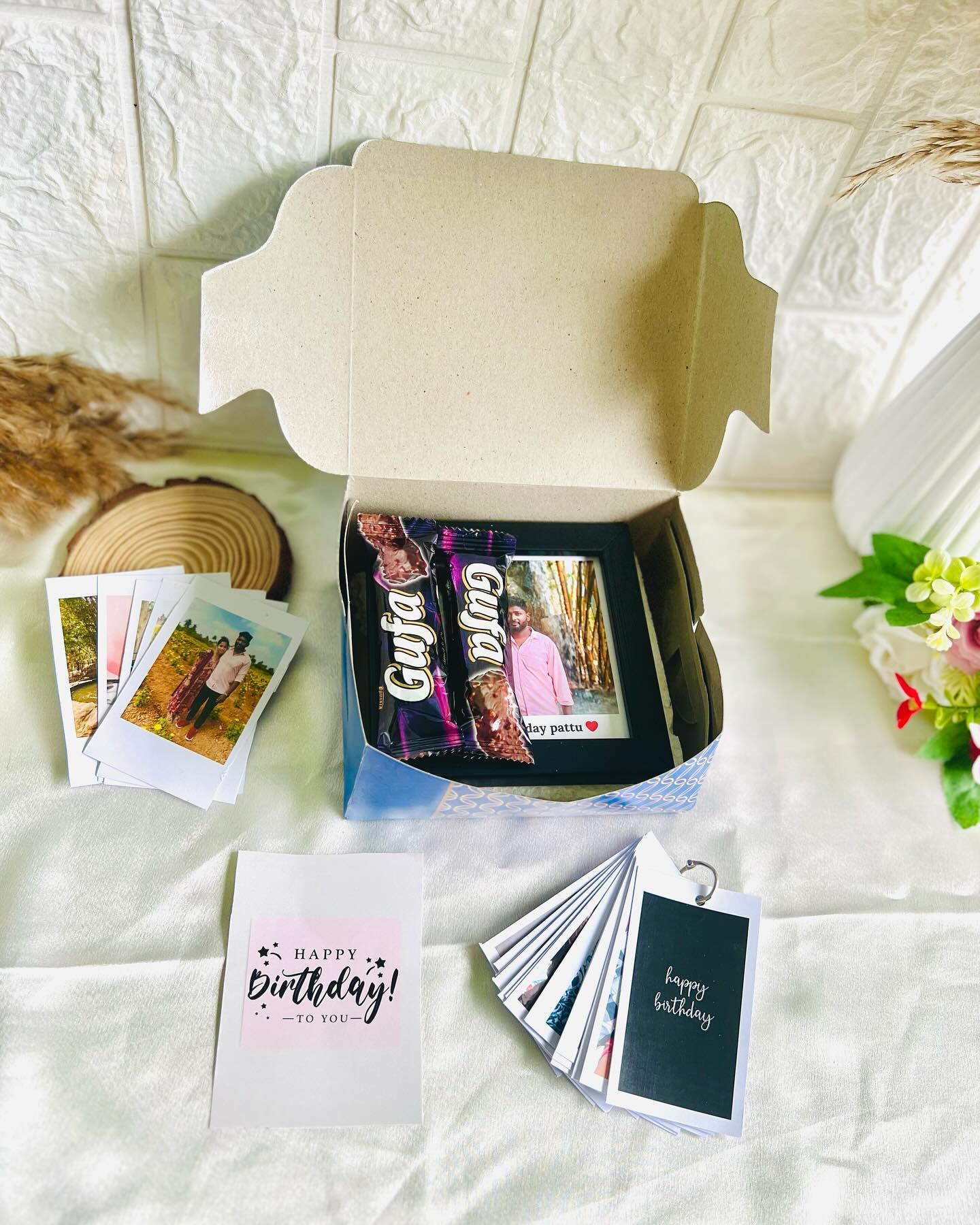 A sleek black photo frame personalized with a couple photo and a printed 'Happy Birthday' message.