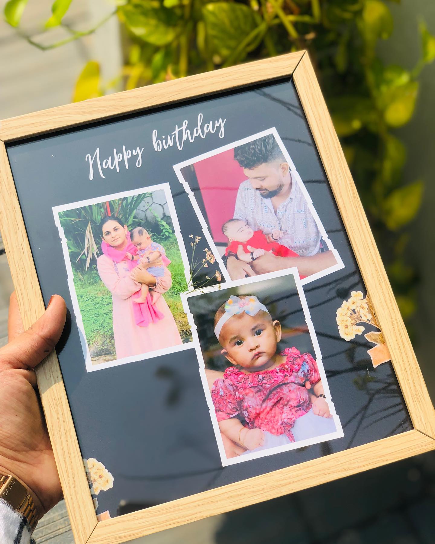 A wooden collage frame arranging three personalized family photos beneath a printed 'Happy Birthday' script.