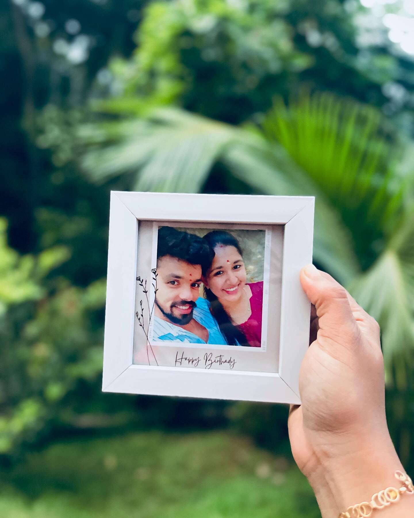 A compact square photo frame featuring a couple's selfie and a handwritten-style Happy Birthday note.