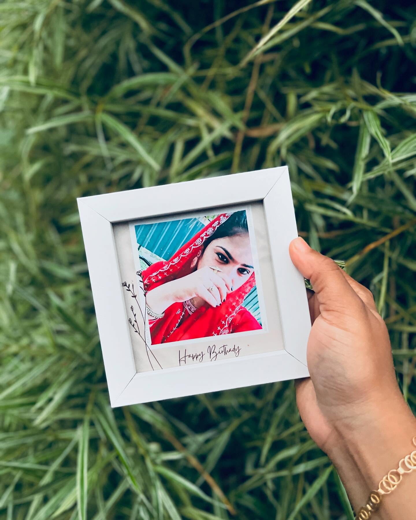 A personalized mini frame printing a favourite portrait with a handwritten Happy Birthday caption.
