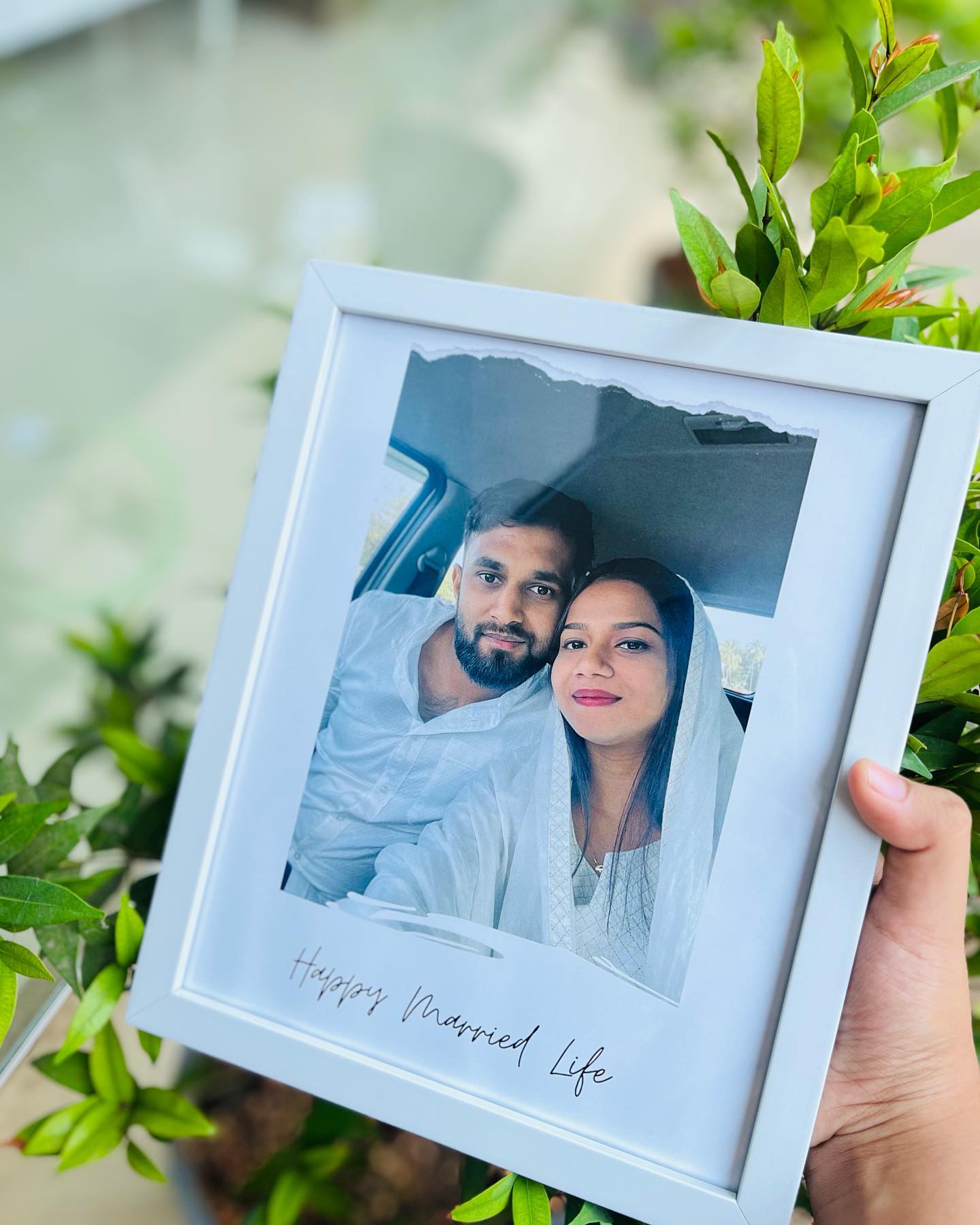 A custom couple photo set in a clean white frame with a handwritten 'Happy Married Life' caption.