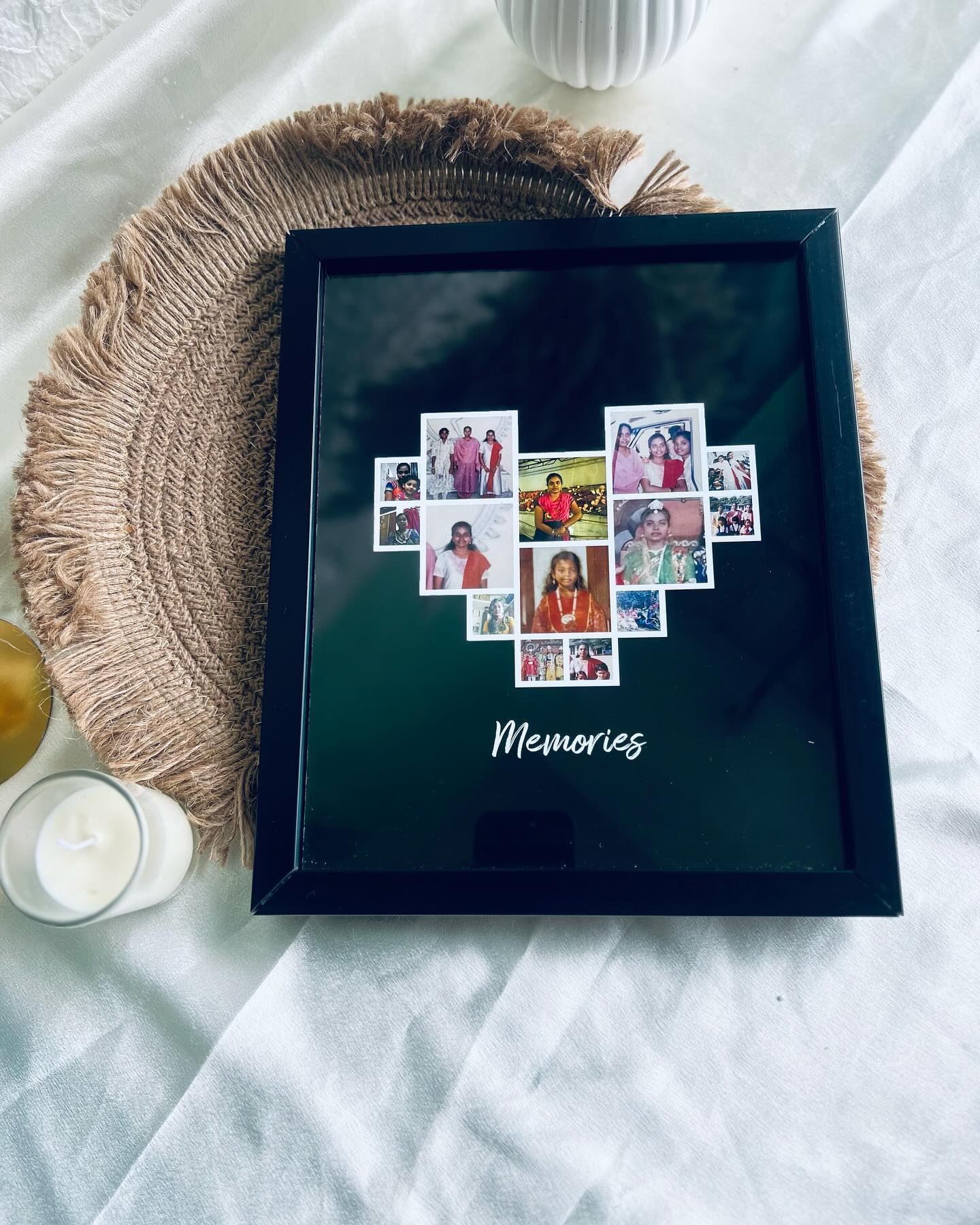 A black frame arranging a lifetime of photos into a heart shape beneath the word "Memories."
