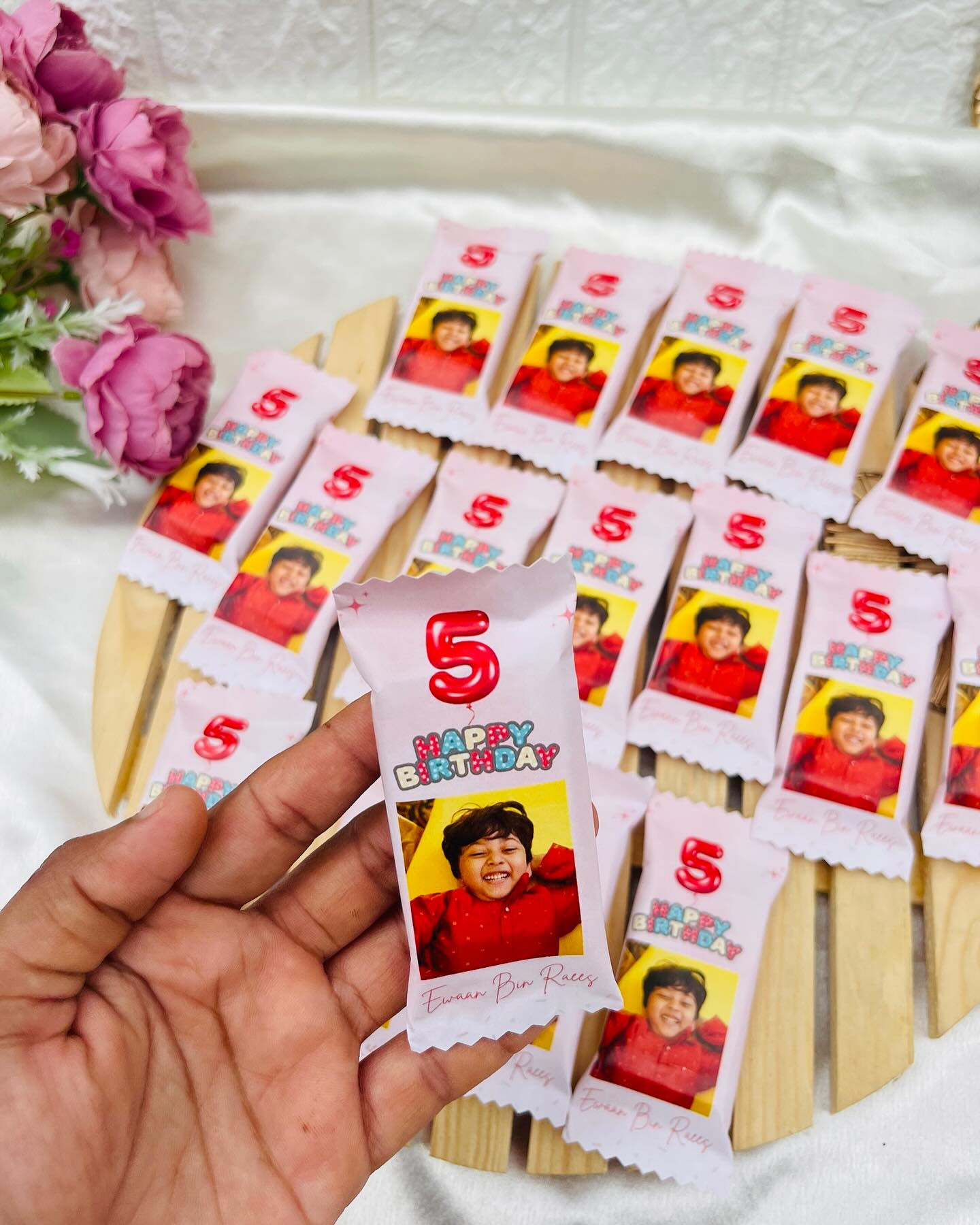 A set of chocolate favor bars personalized with a child's photo, name, and a bold '5' birthday balloon graphic.