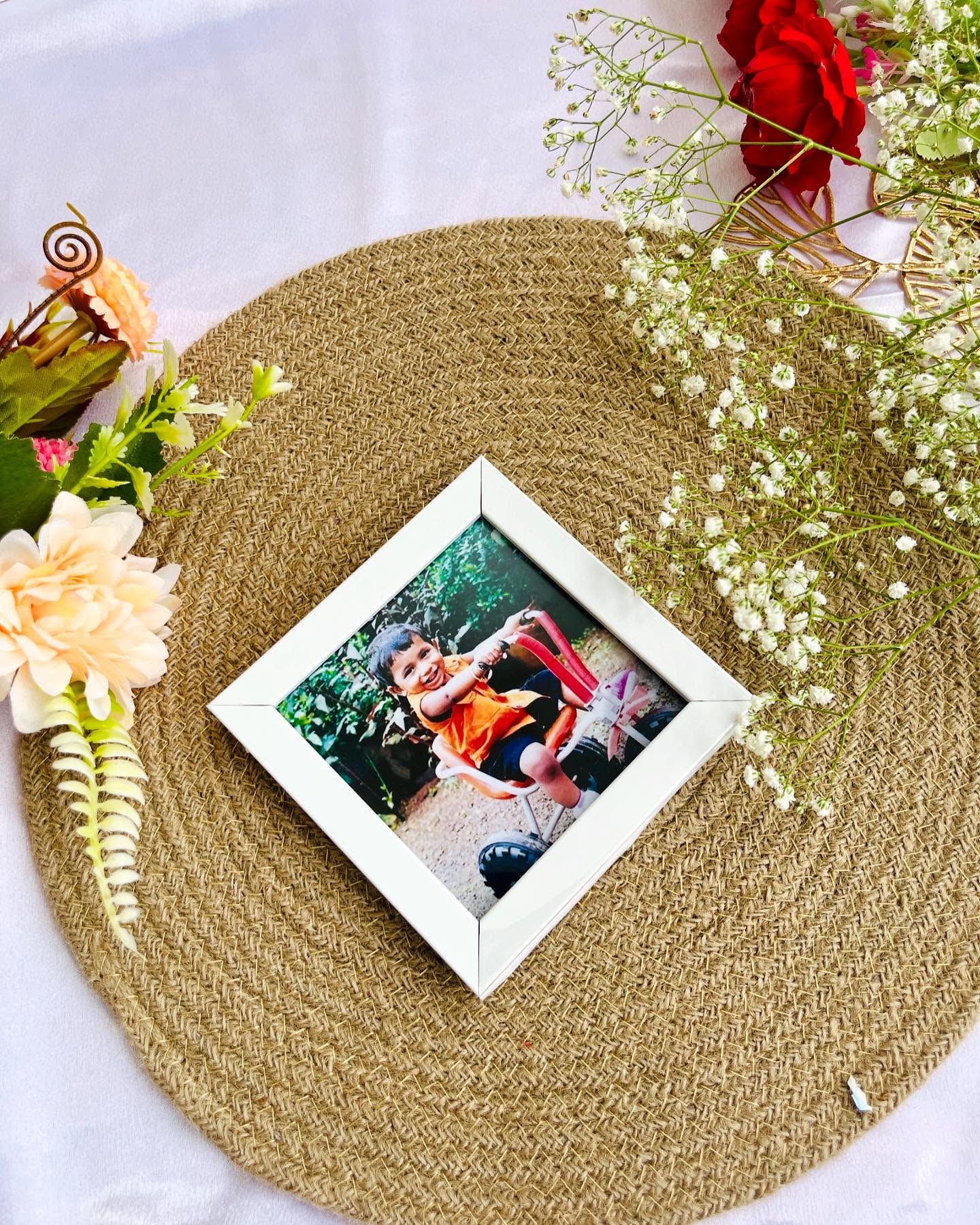 A charming personalized photo frame styled with soft blooms and greenery for a cherished keepsake.