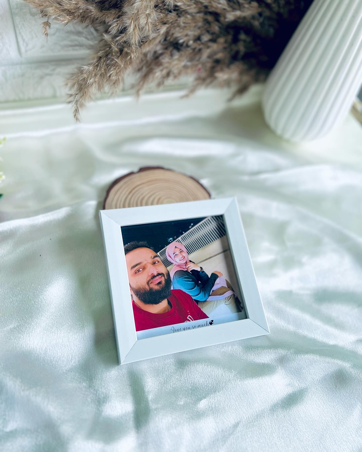 A minimalist white frame personalized with a couple's photo and loving caption.