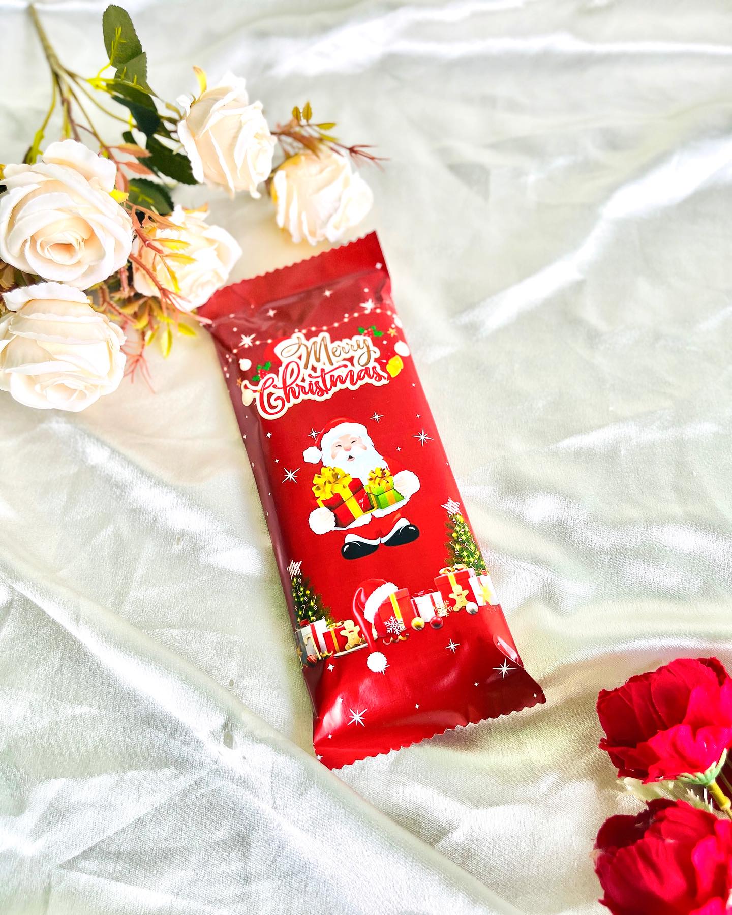 A festive Santa-themed chocolate bar wrapped in cheerful holiday packaging.
