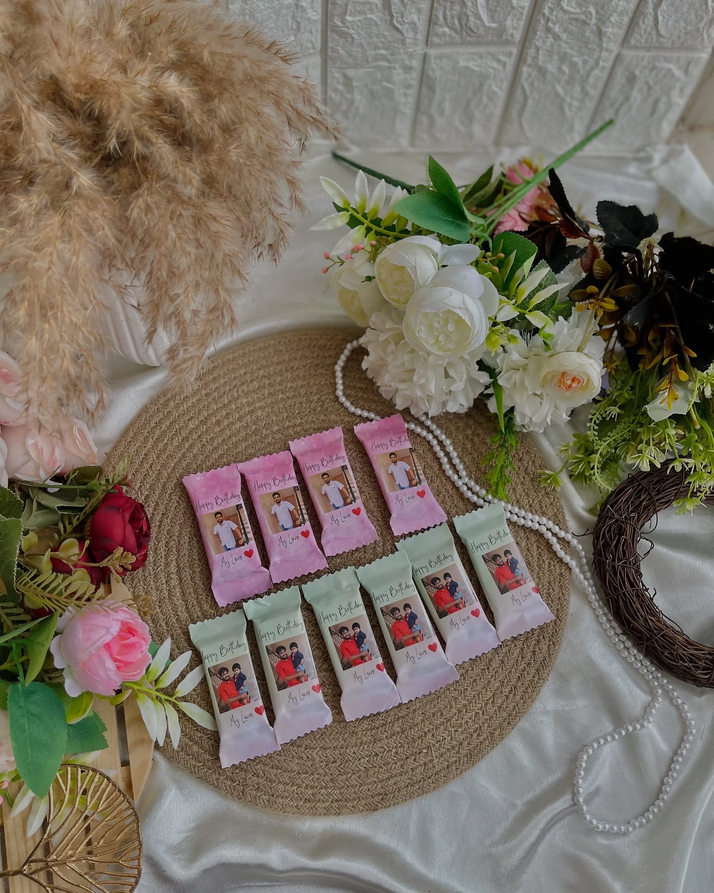 A bunch of mini chocolate bars wrapped in pink photo sleeves reading "Happy Birthday, My Love".