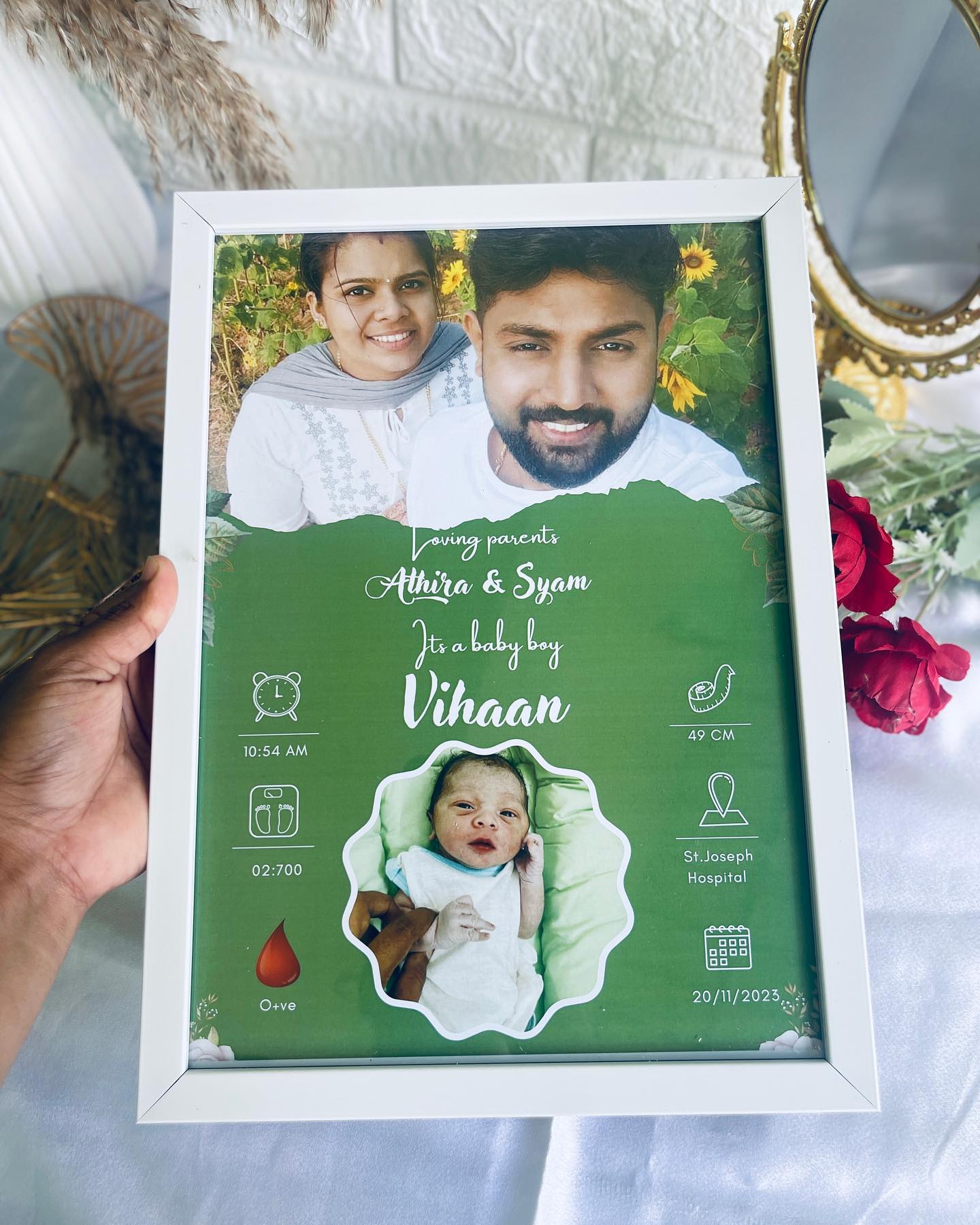 A personalized keepsake frame announcing a newborn's name, stats and proud parents' photo.