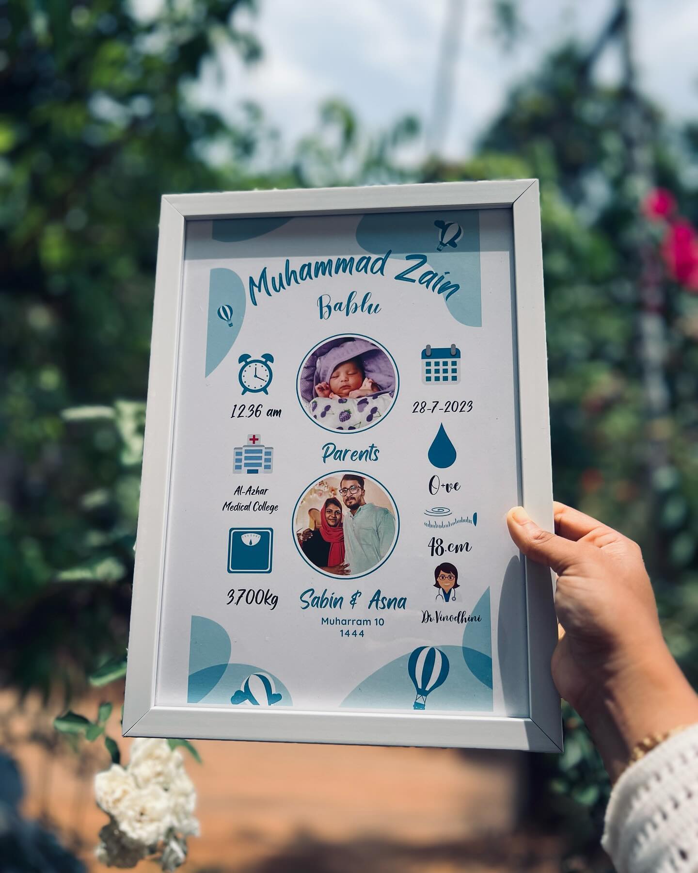 A personalized birth-announcement poster frame with the baby's photo, parents, and birth details.