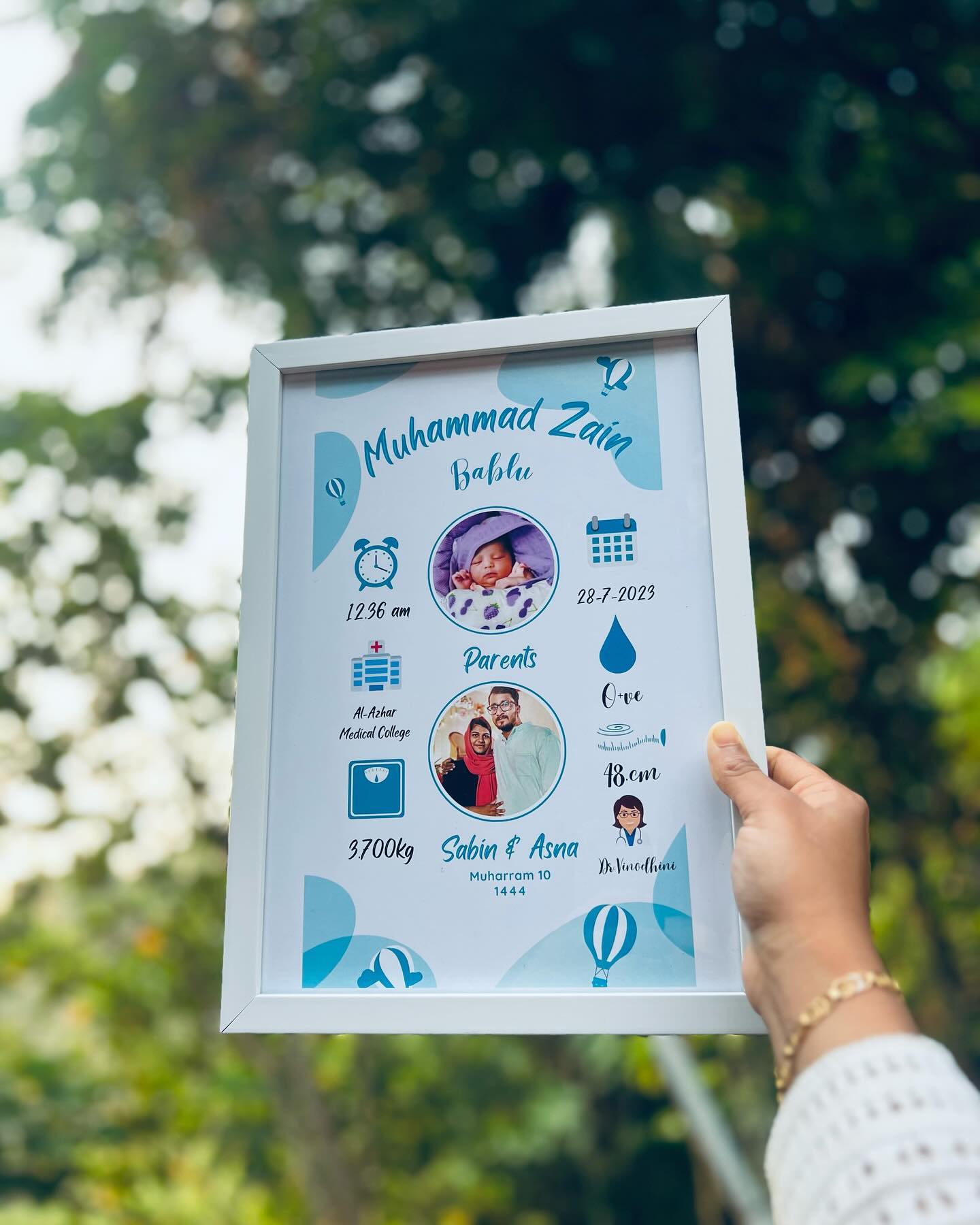 A custom-designed keepsake frame capturing a newborn's name, birth date, and vital stats.